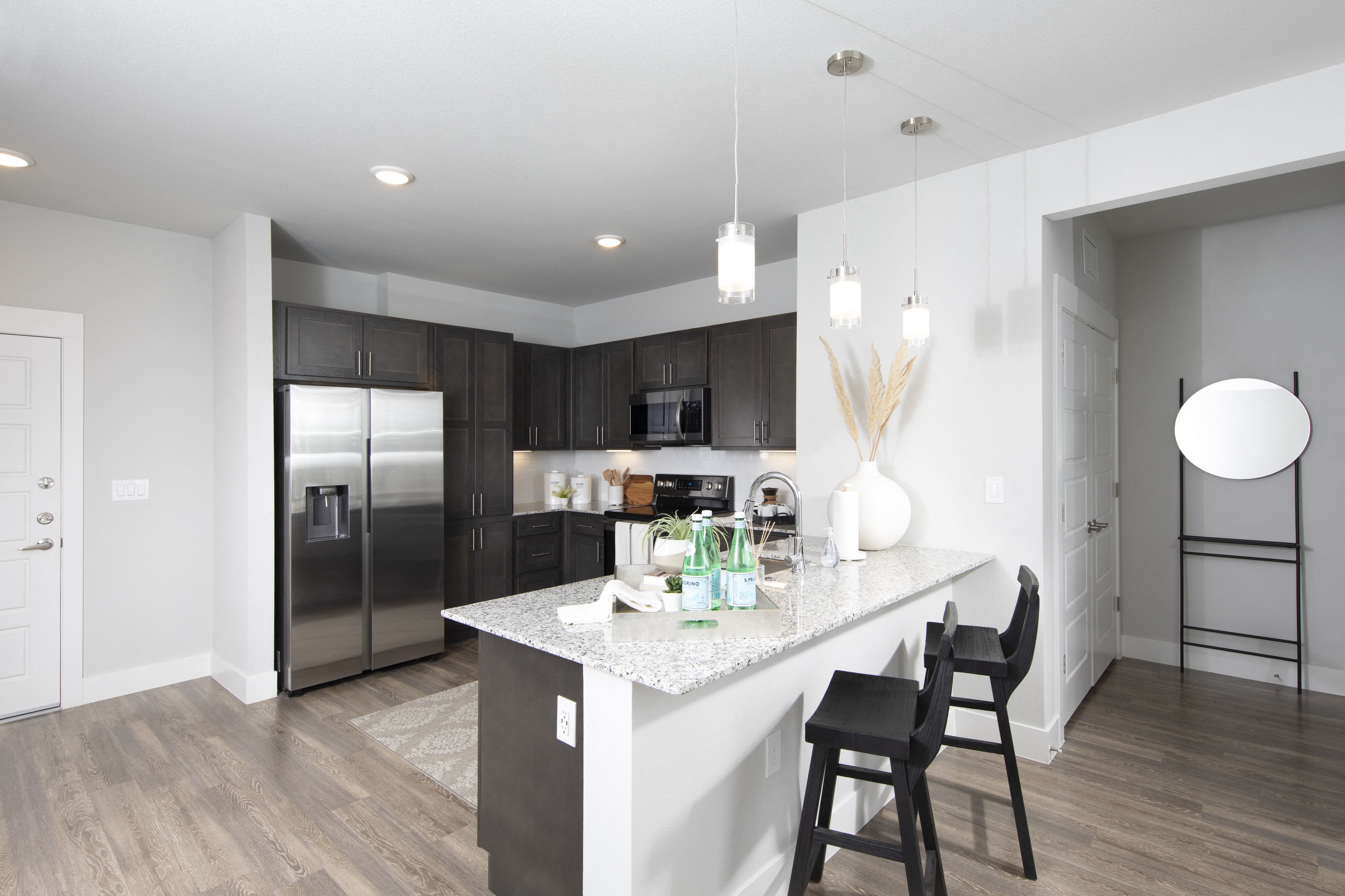a kitchen with stainless steel appliances and a granite counter tops at a senior apartment community