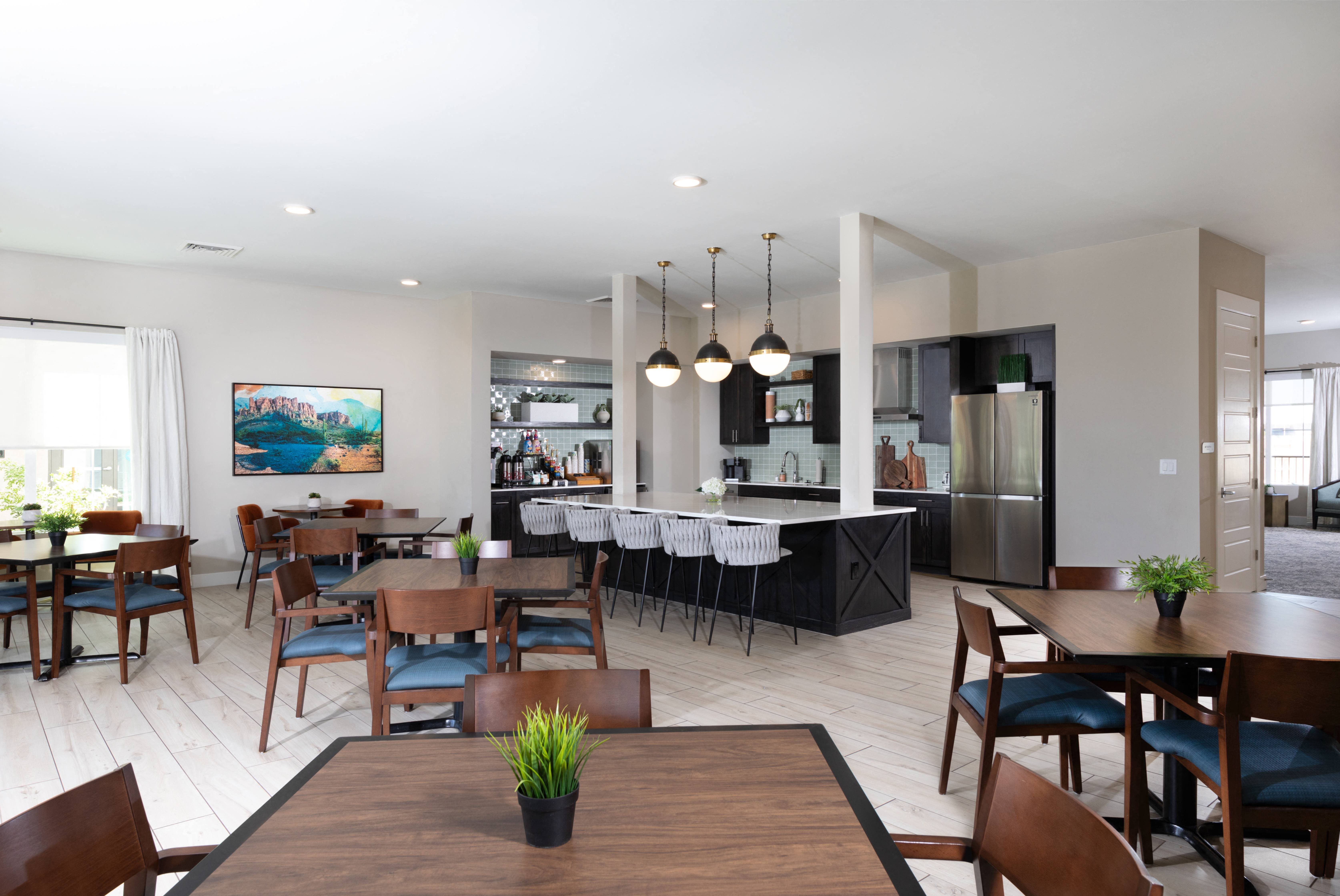a community clubhouse dining room and kitchen at a senior apartment community