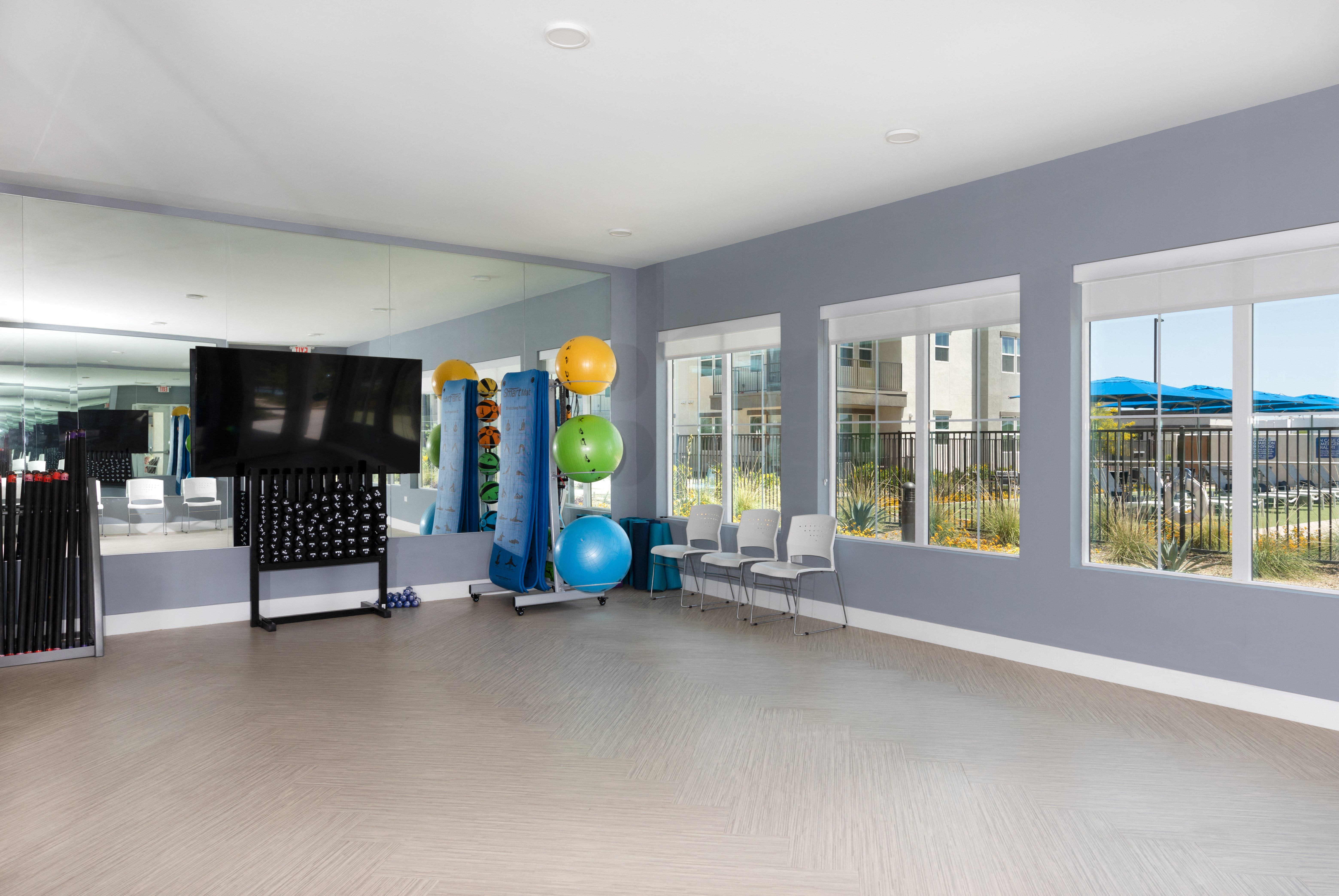 a fitness room with workout equipment at a senior apartment community