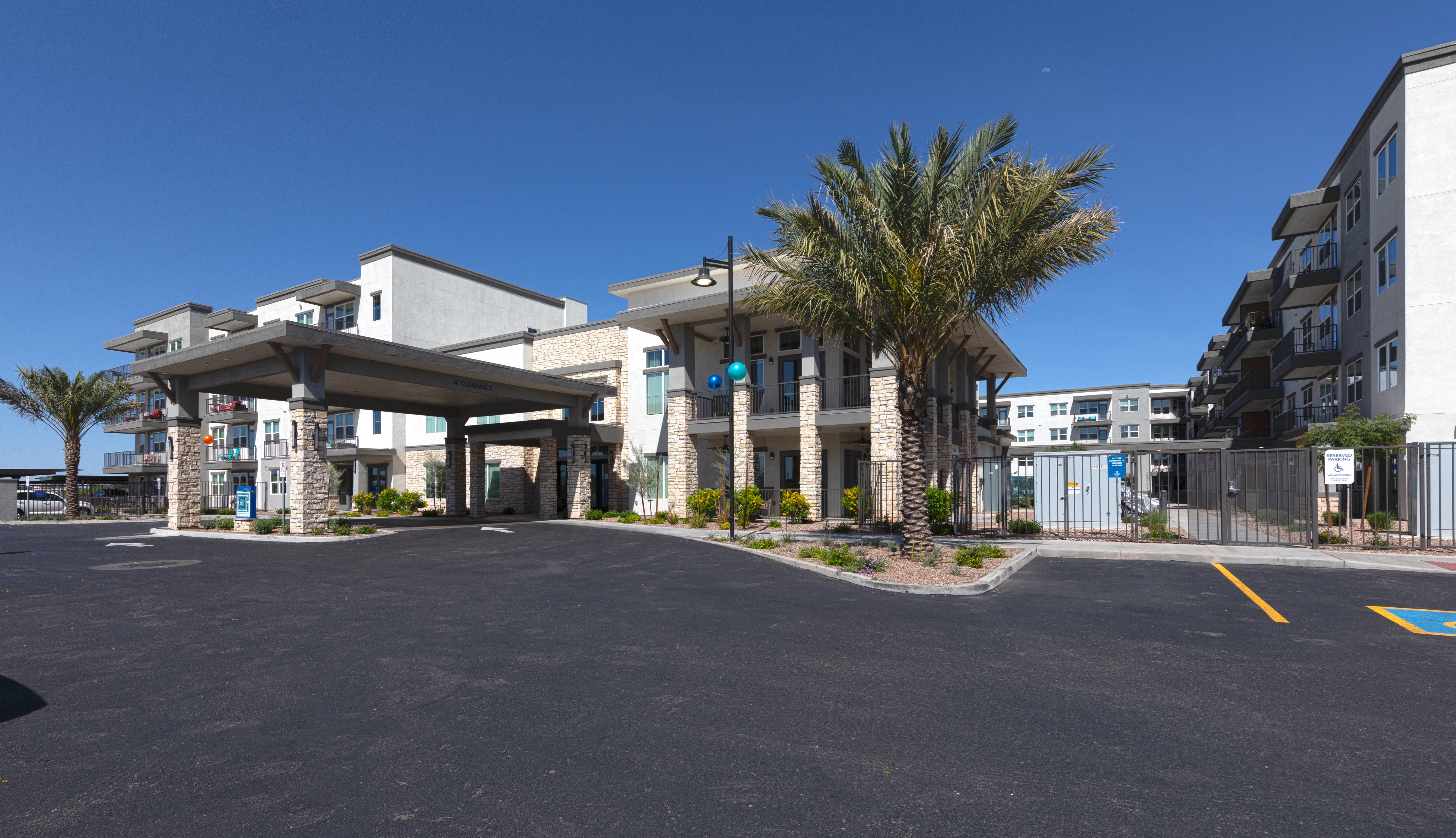an outside view of the main entrance to a senior apartment community
