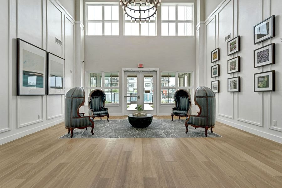 a large lobby with a chandelier and sitting area at a senior apartment community