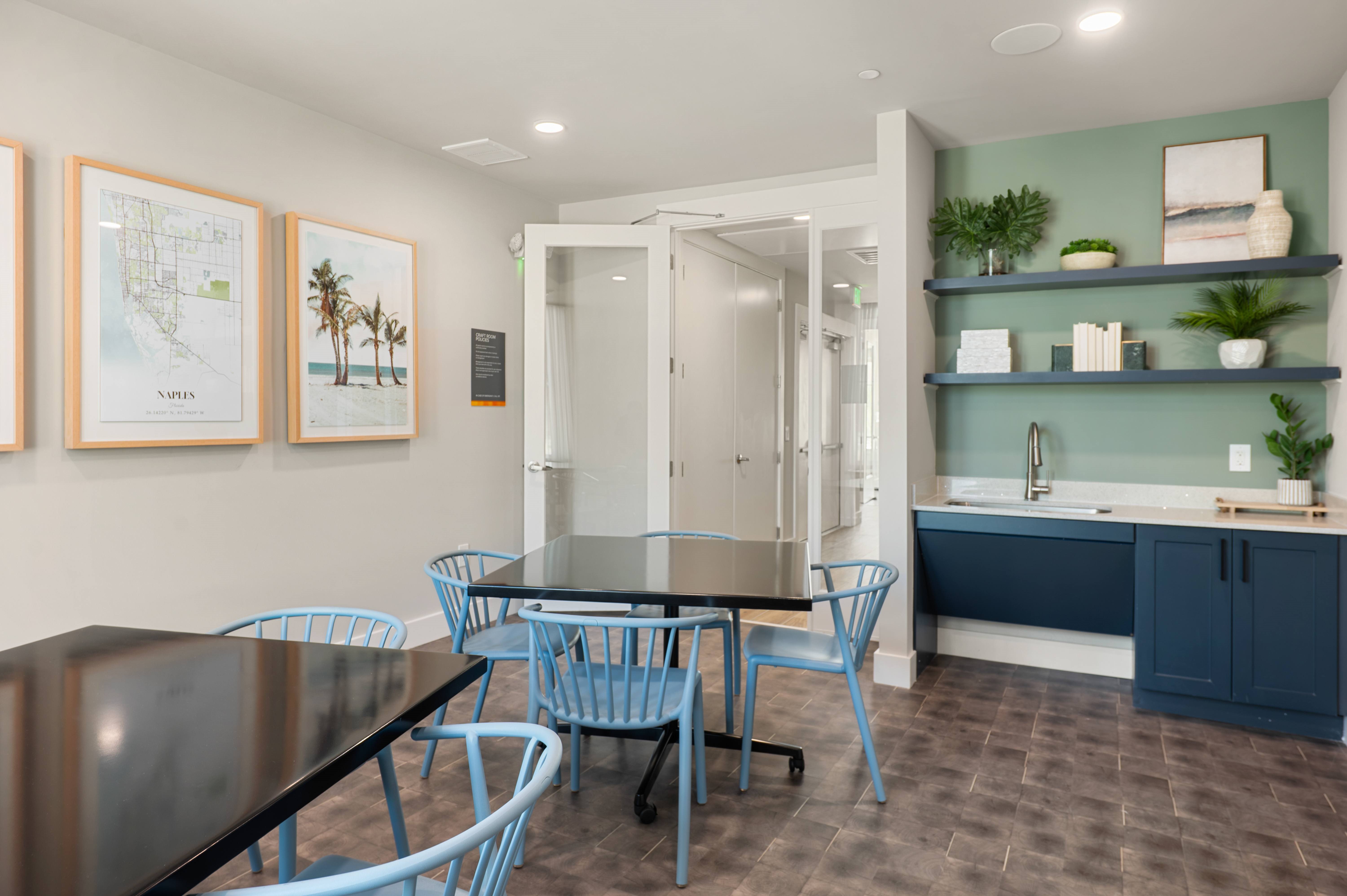 A kitchen with a table and chairs in the middle of the room.