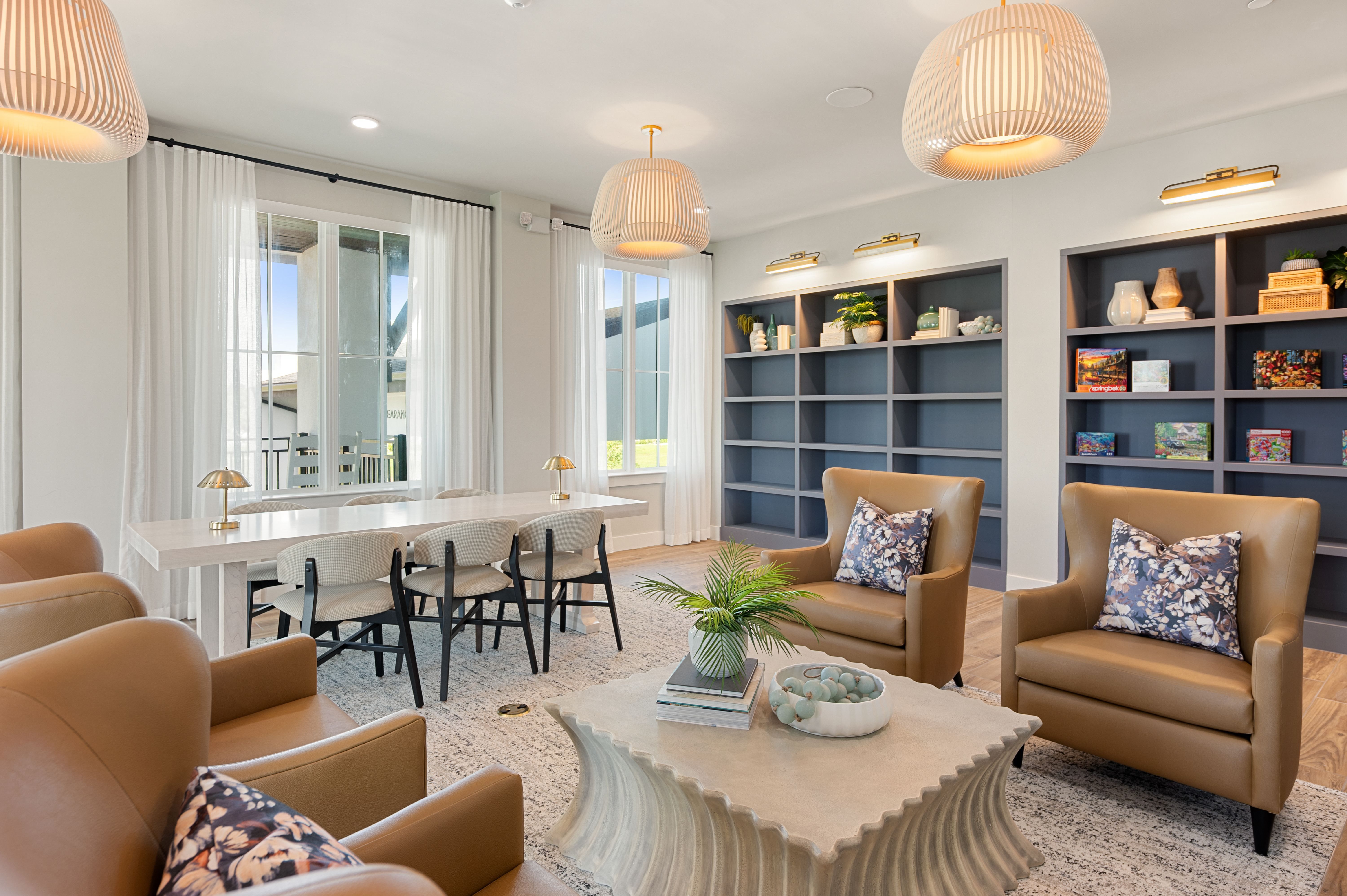 A living room with brown leather chairs and a coffee table.