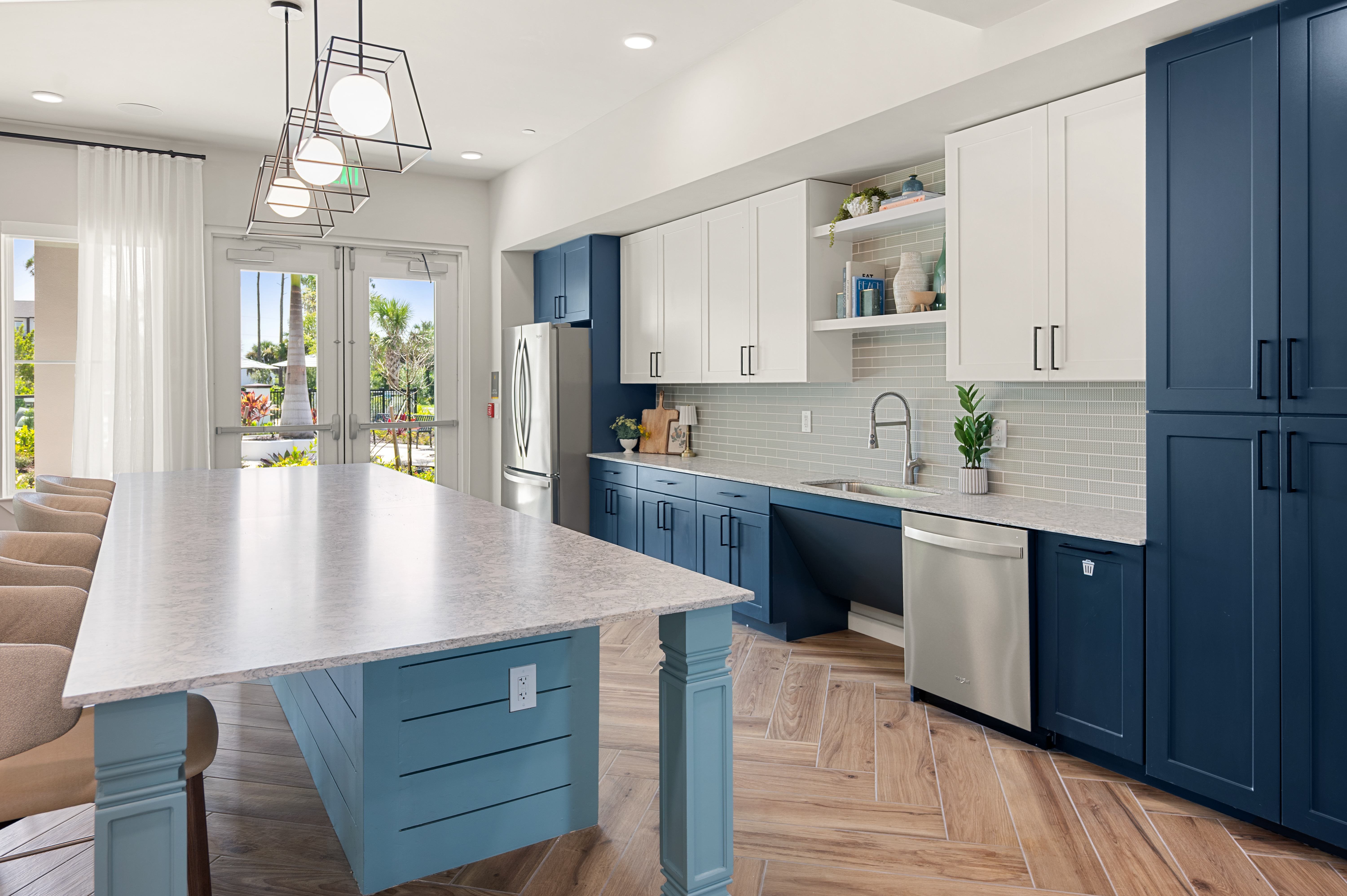A kitchen with a table and chairs and a refrigerator.