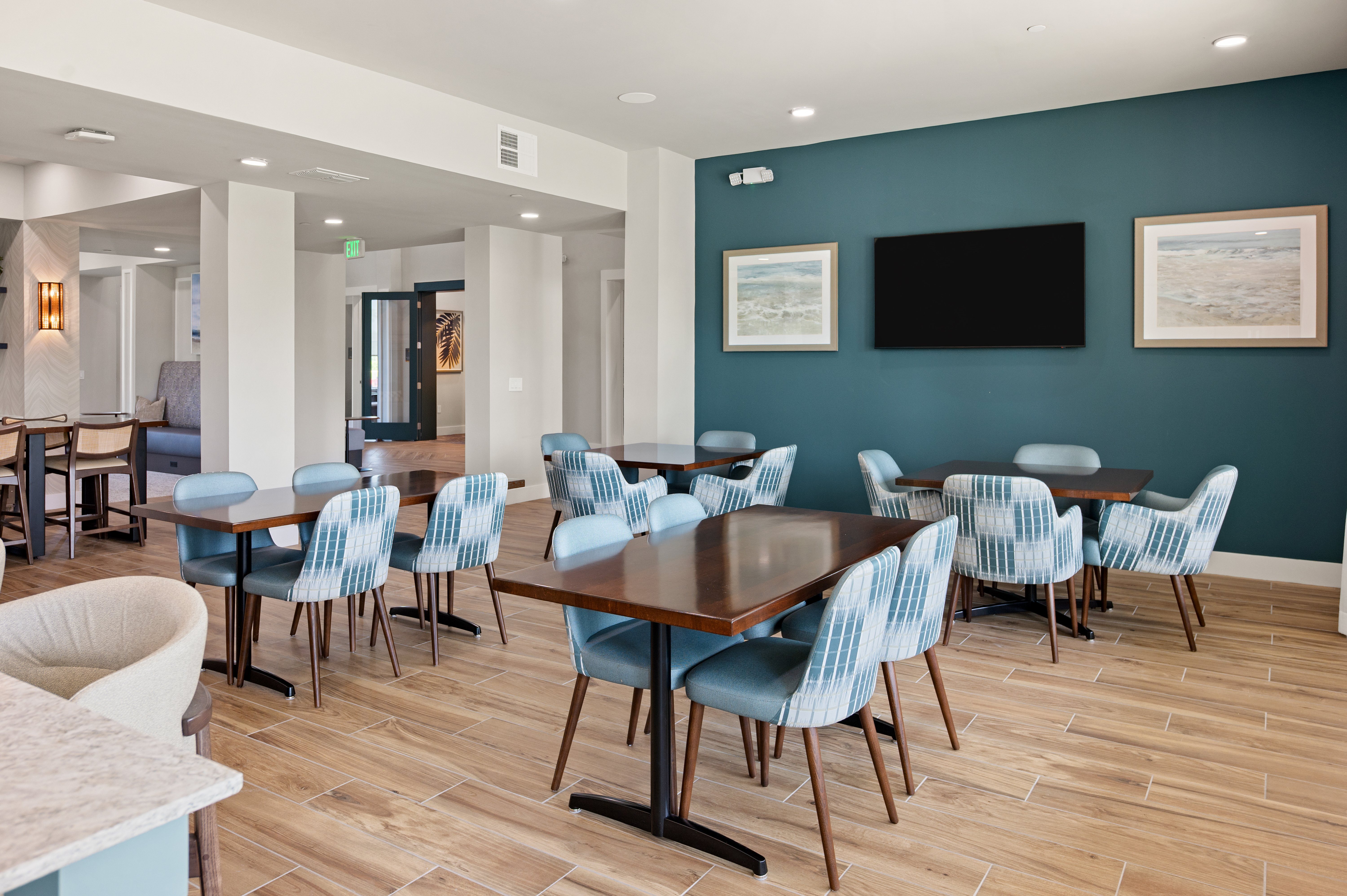 A room with a long table and chairs.