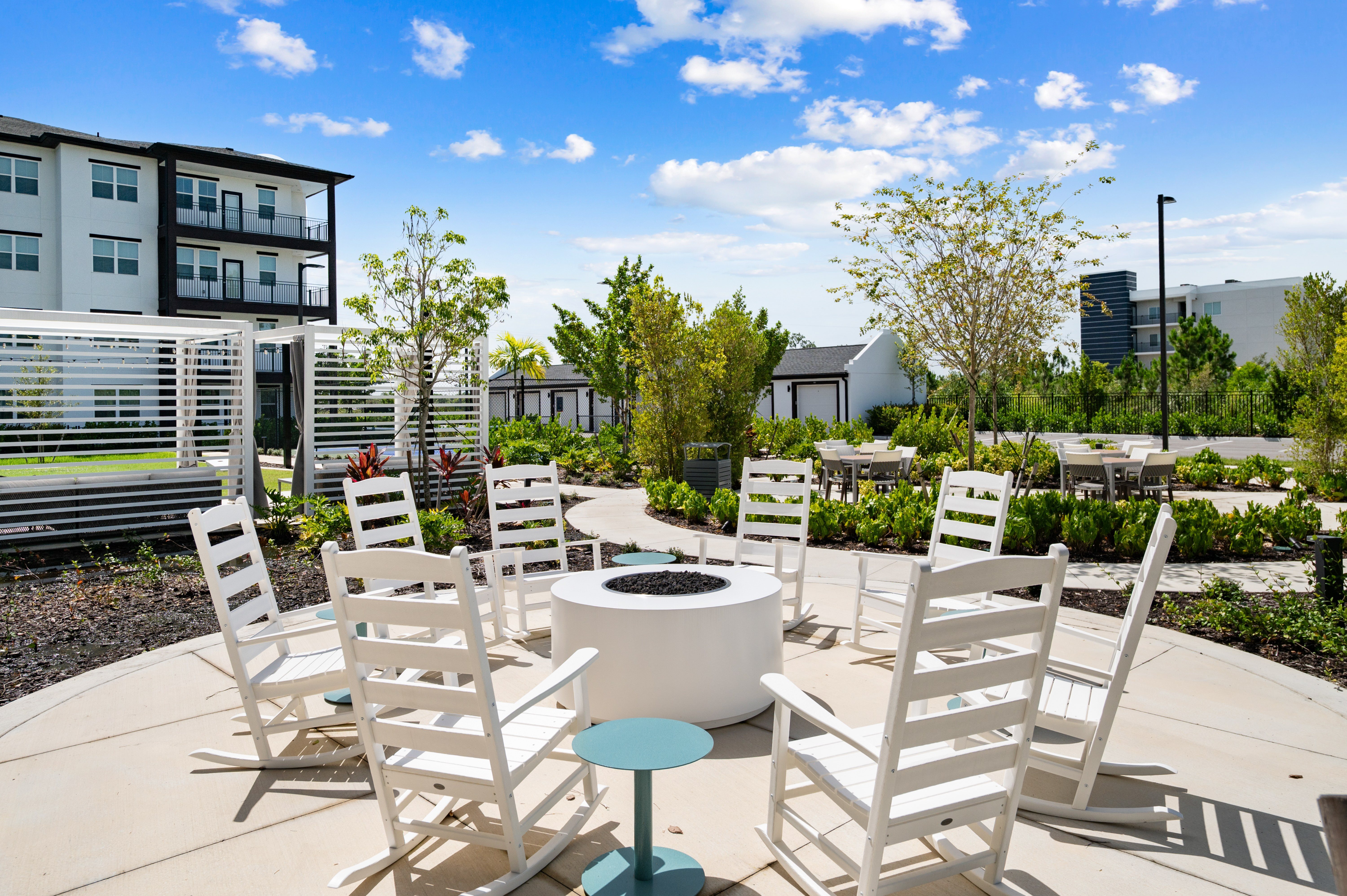 A white wooden chair is in front of a white table.