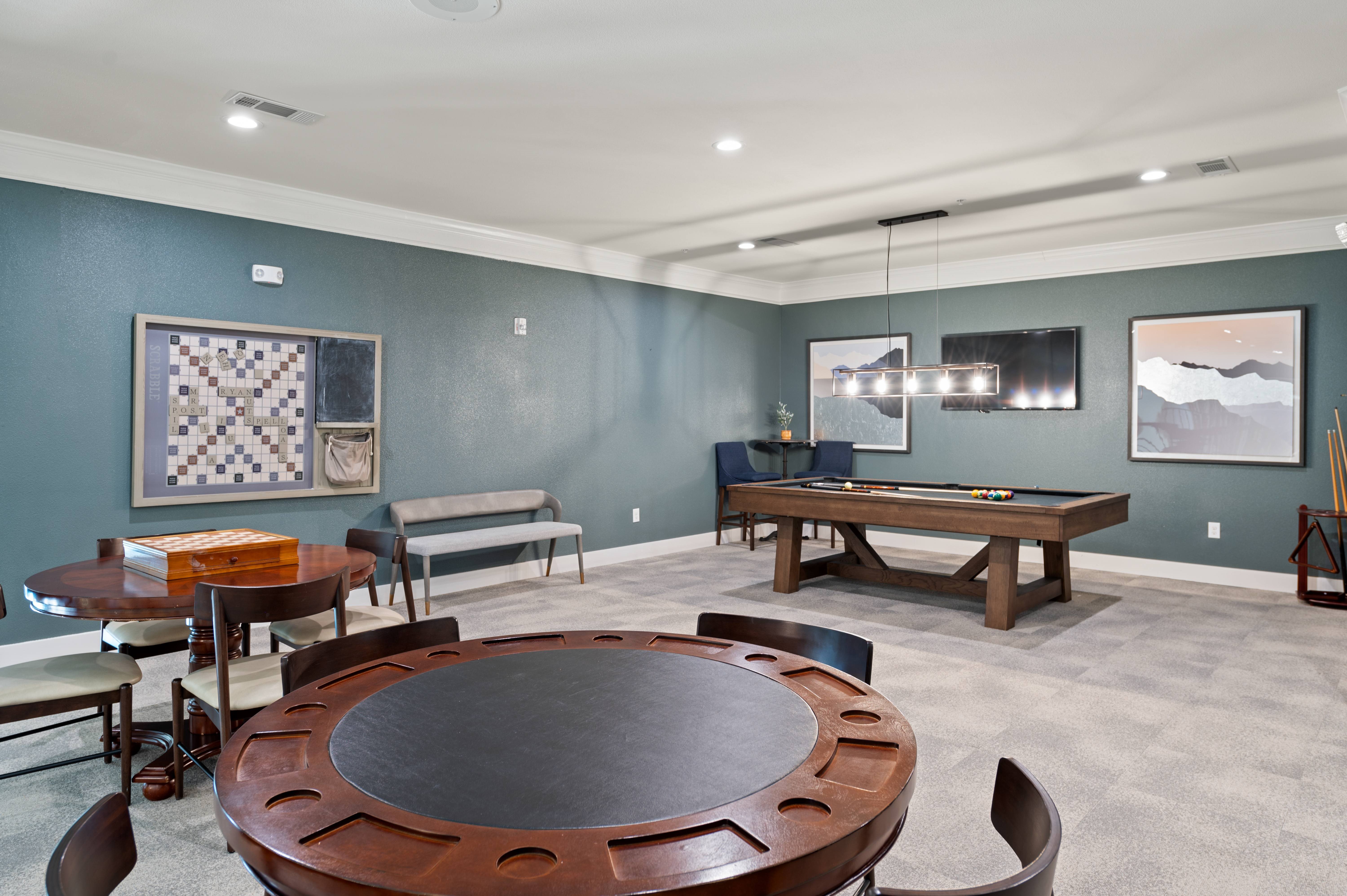 A room with a pool table and a billiard table.