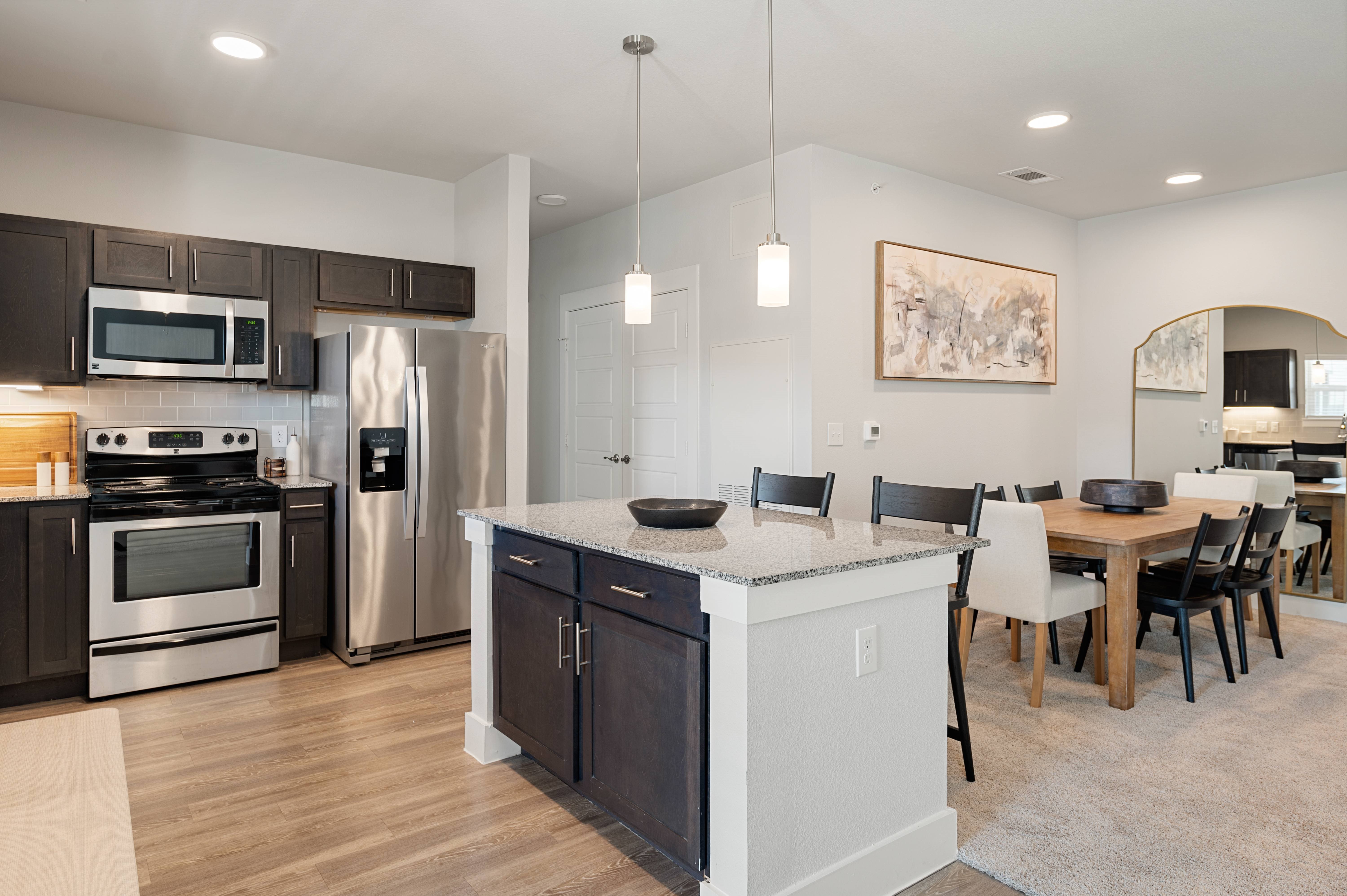 A modern kitchen with a dining table and chairs.