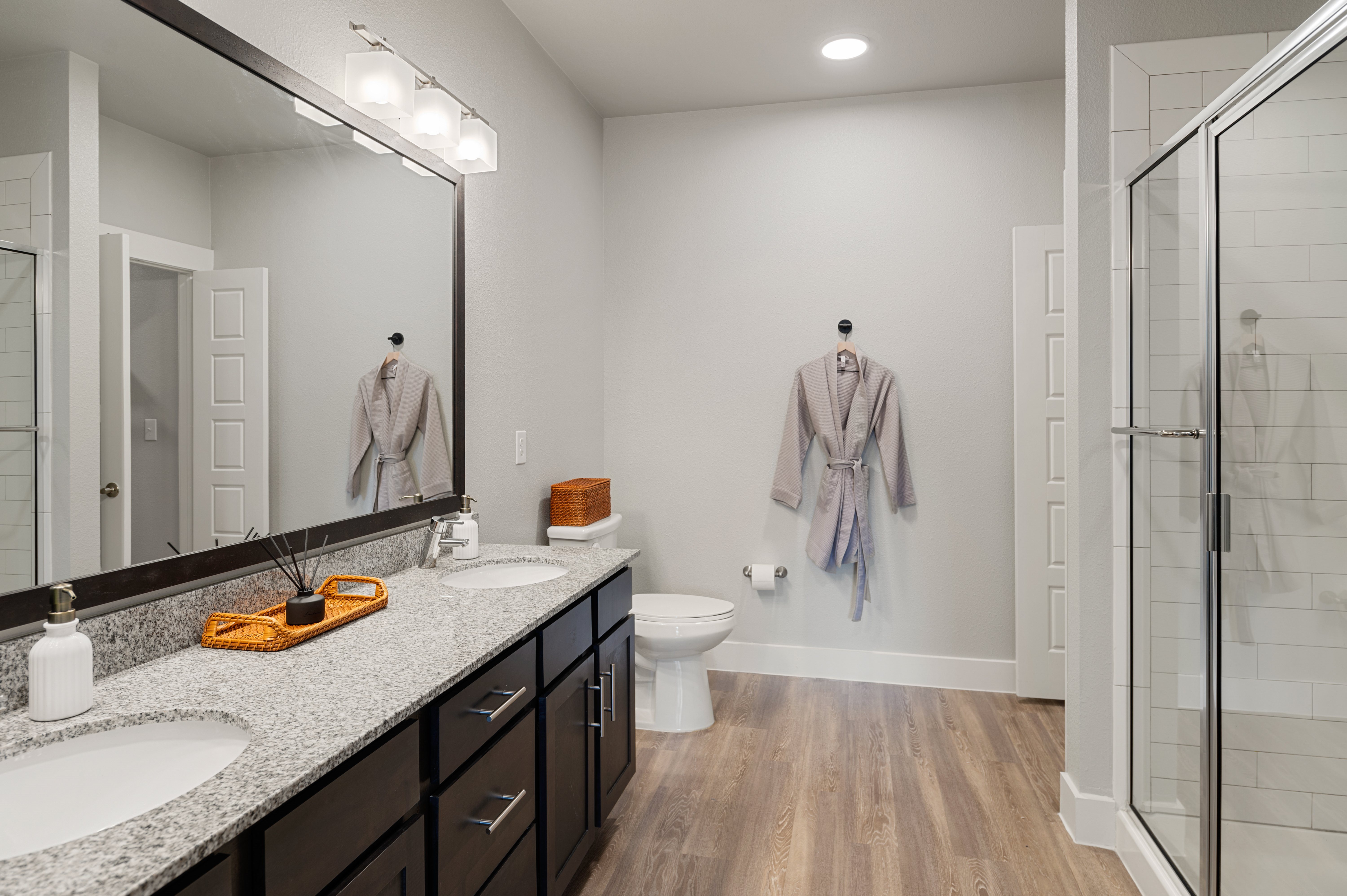 A bathroom with a white toilet and a sink with a mirror above it.