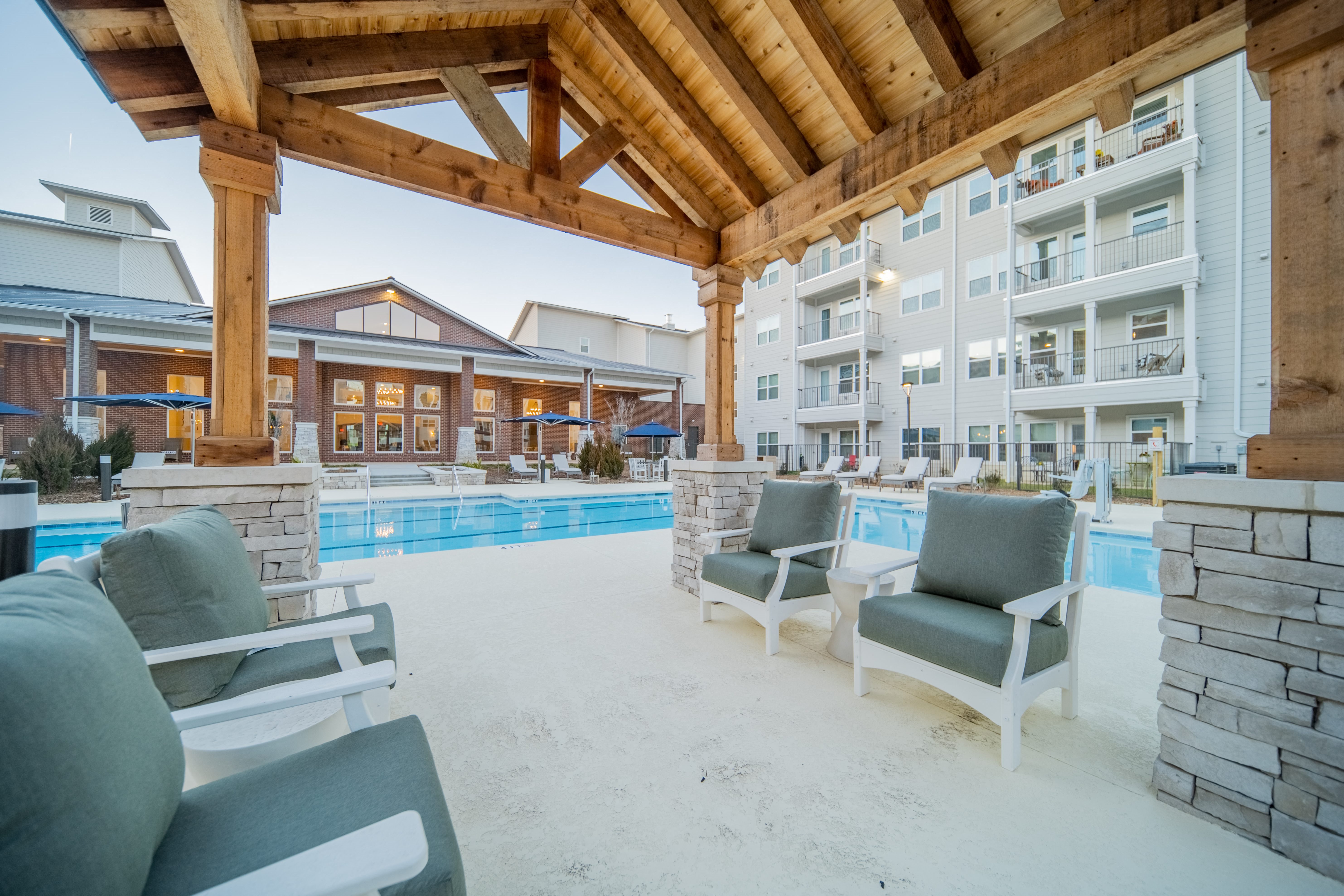a covered patio with seating at a senior apartment community