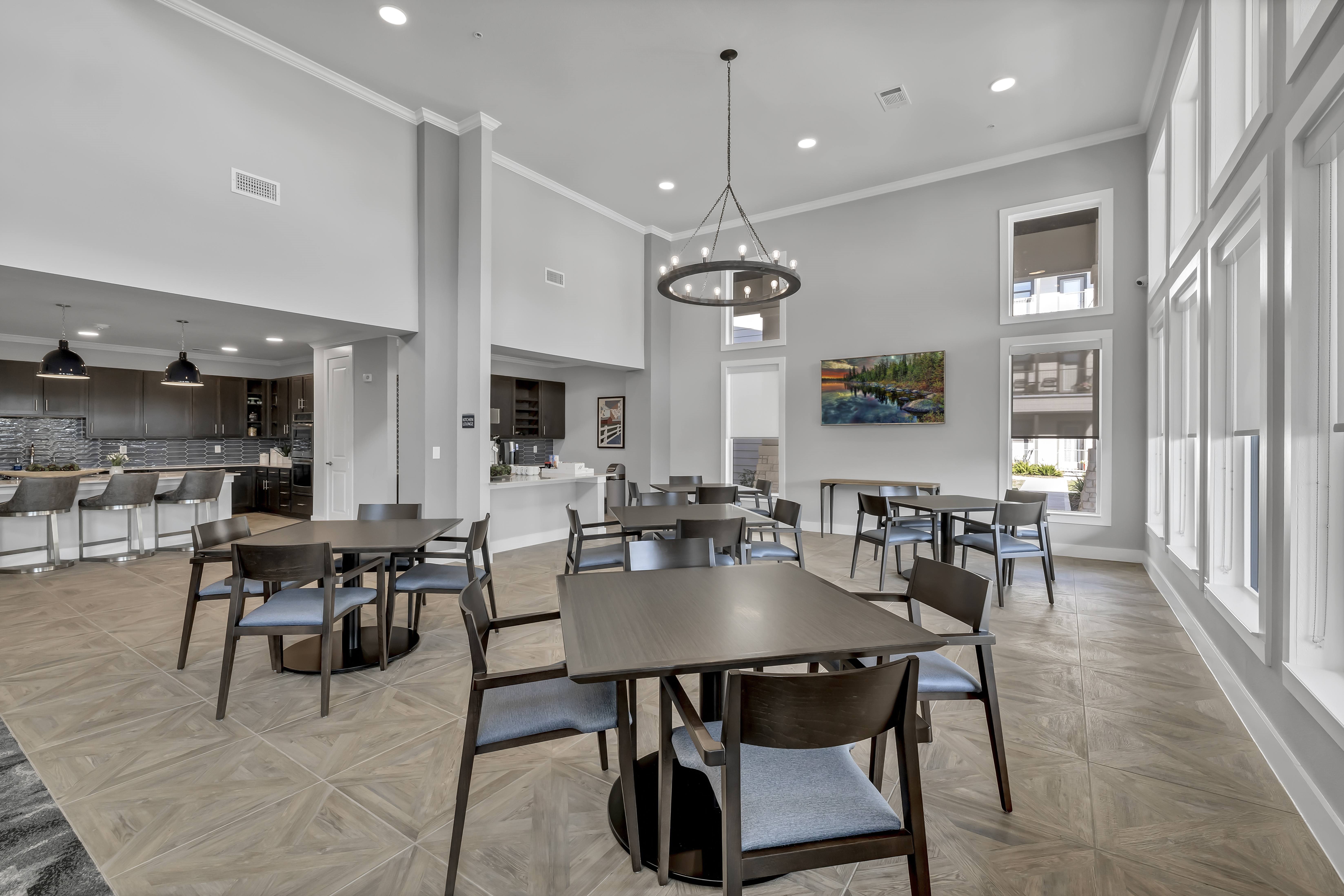 A modern dining room with a large table and chairs.