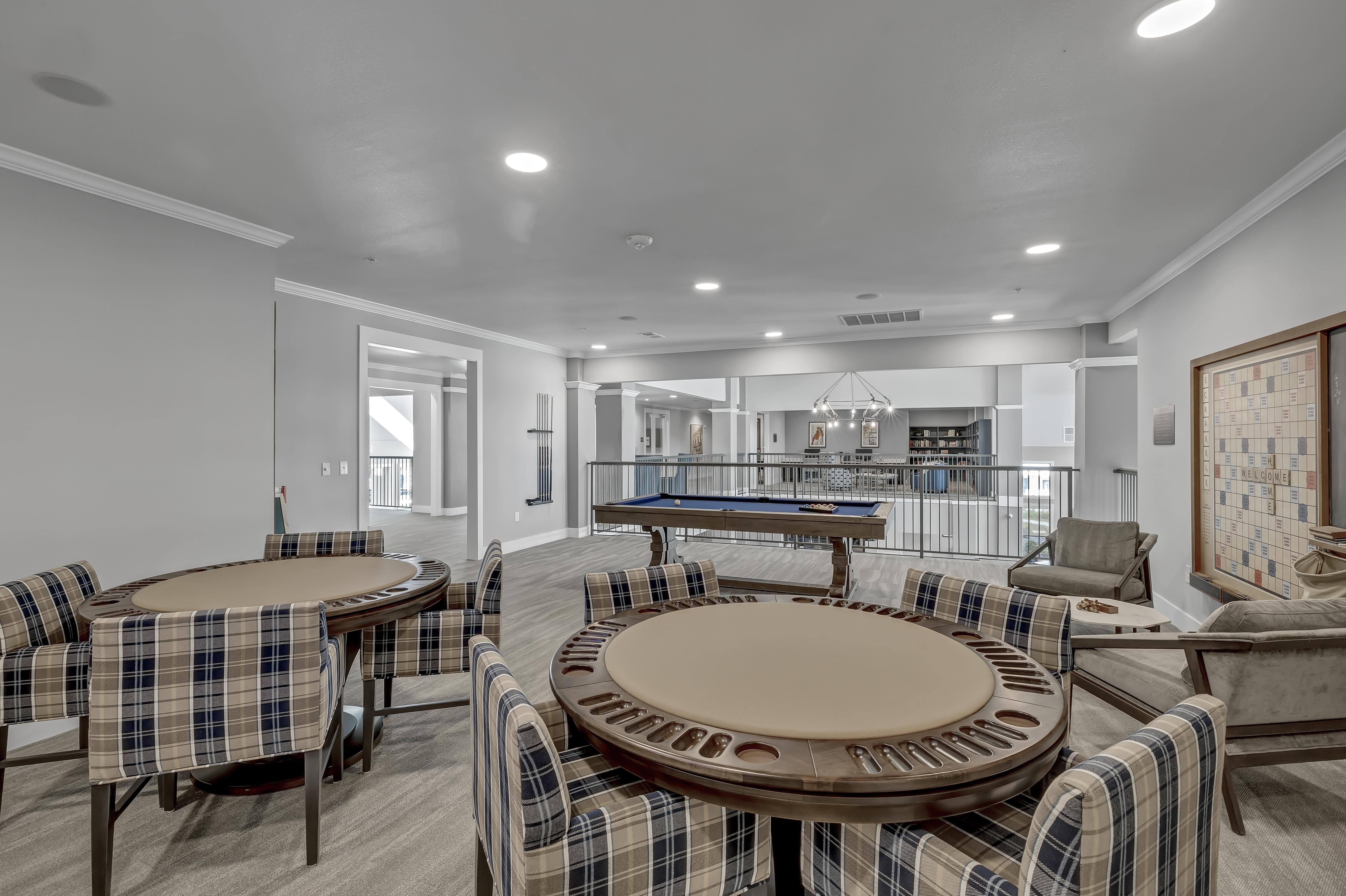 A modern dining room with a large table and chairs.