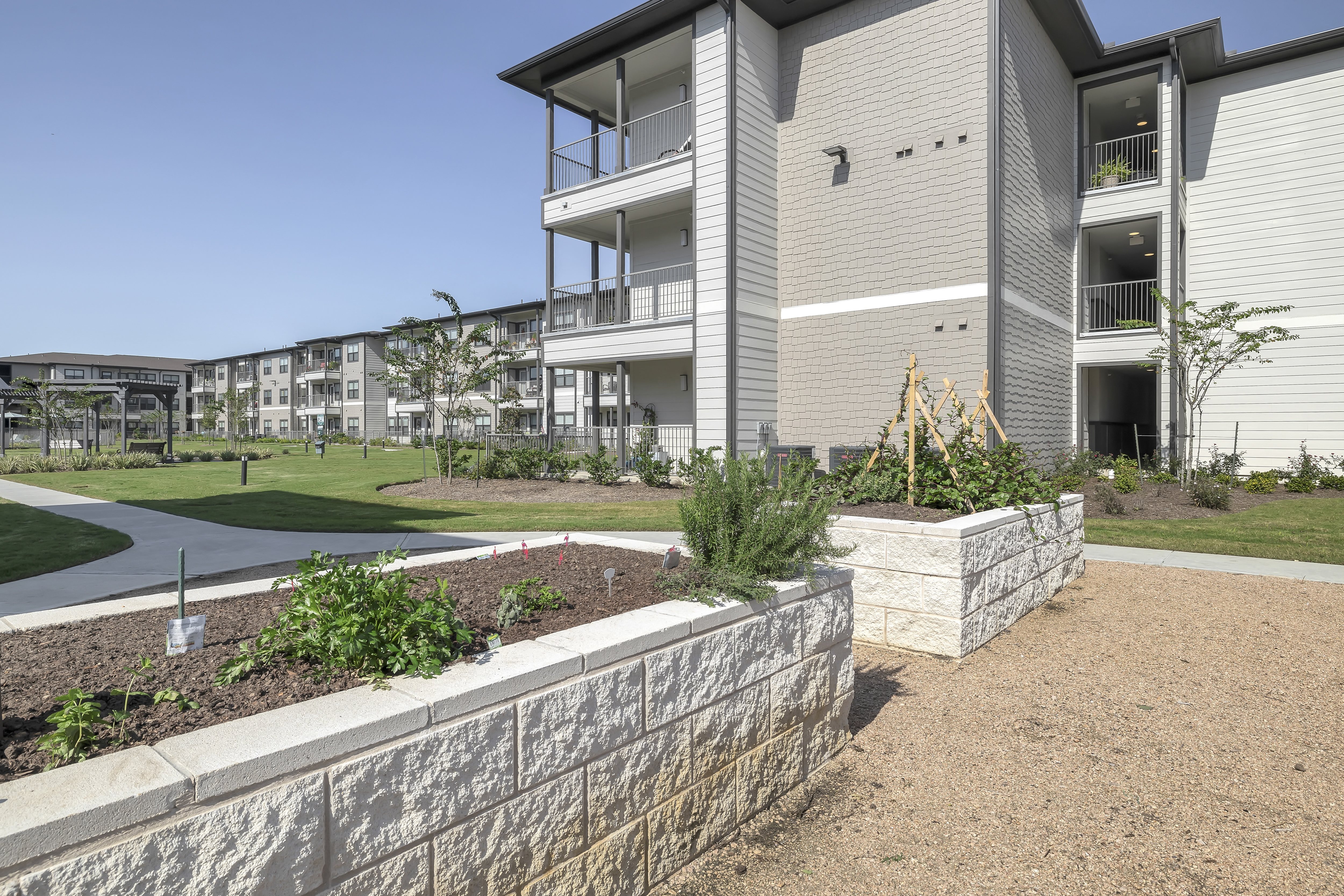 a community garden wit hraised beds at a senior apartment community