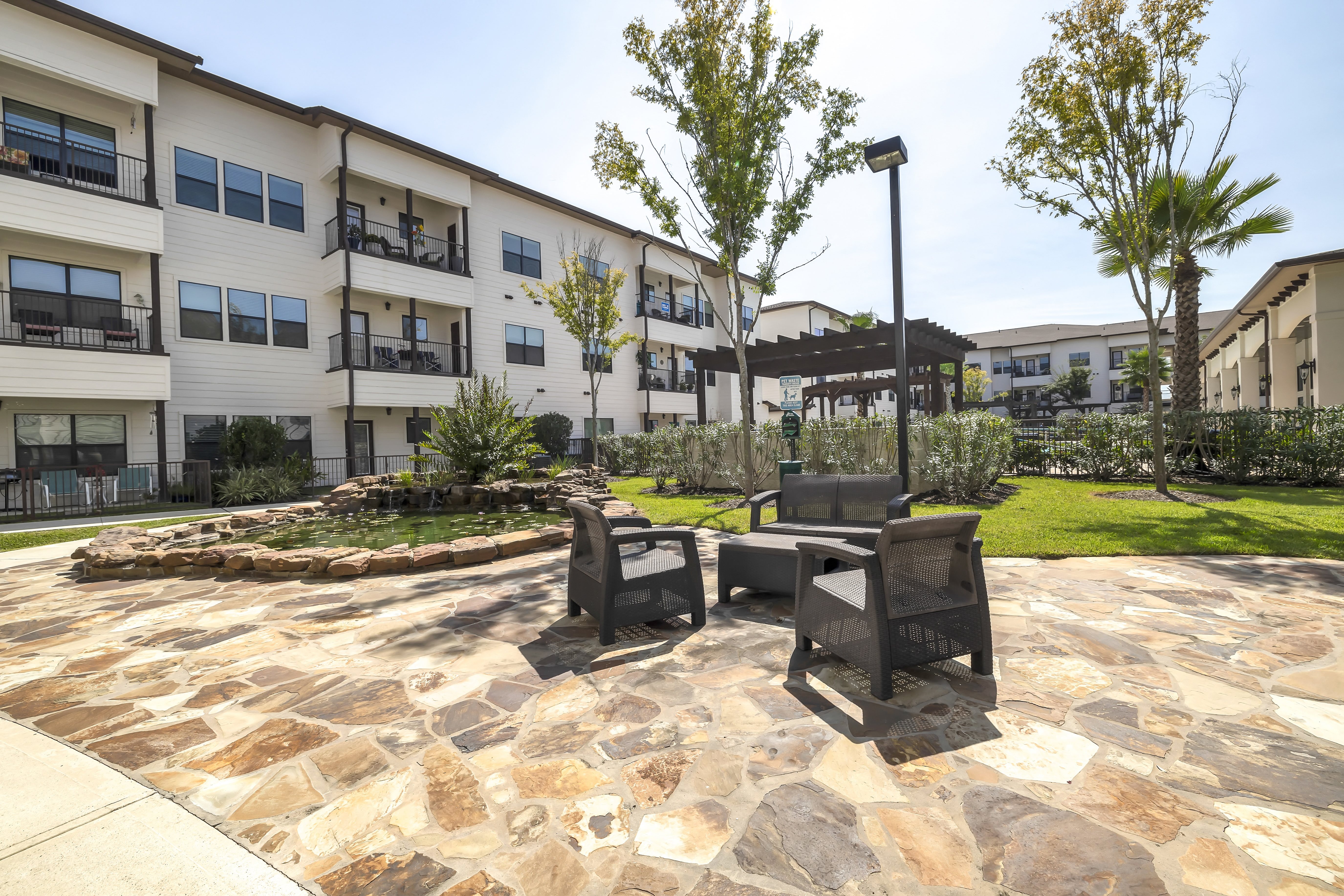 a patio sitting area with a fire pit at a senior apartment community