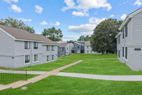 a view of a yard in front of a row of houses