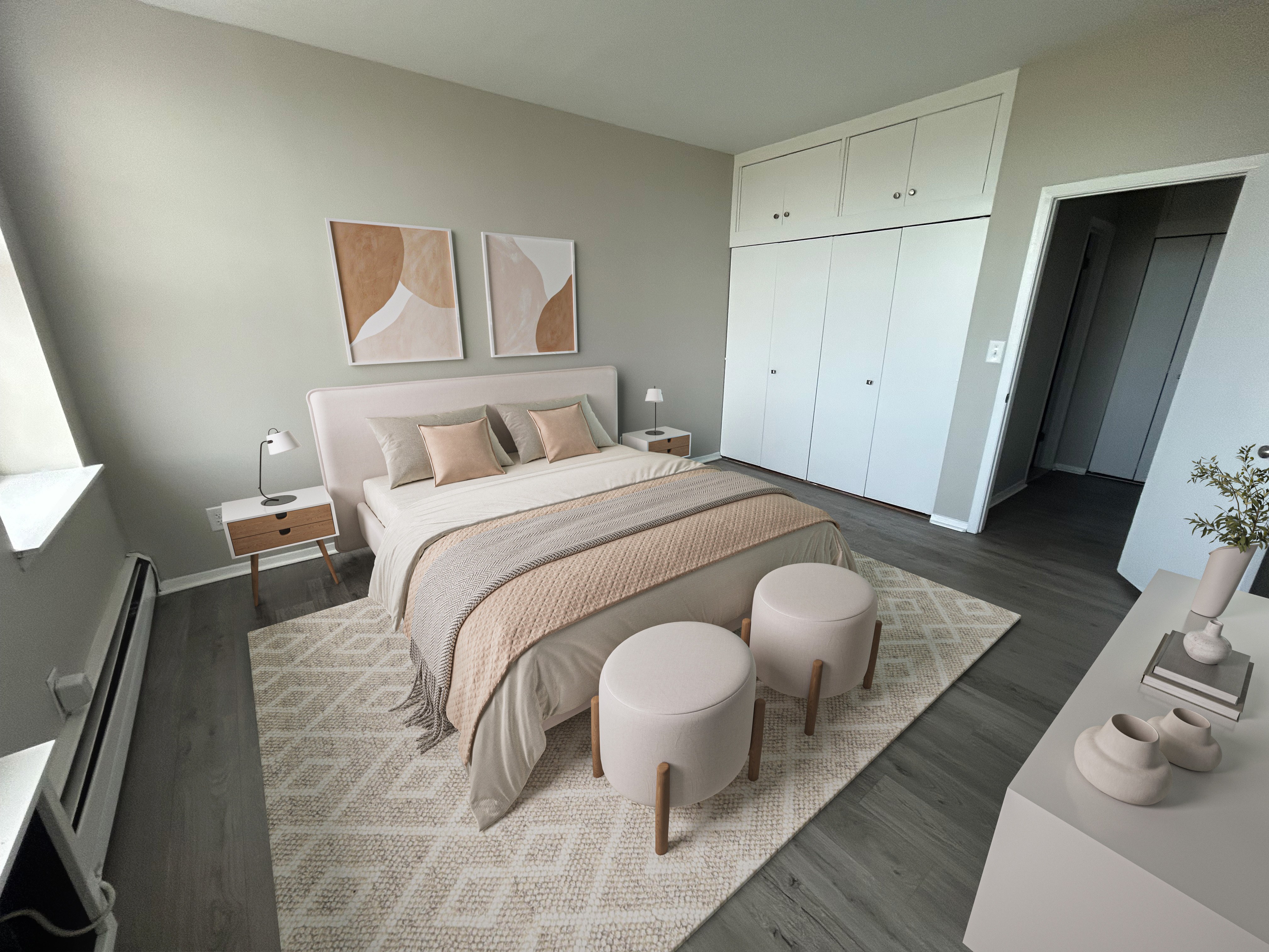 A bedroom with a large bed, a nightstand, and a small table with a vase on it.