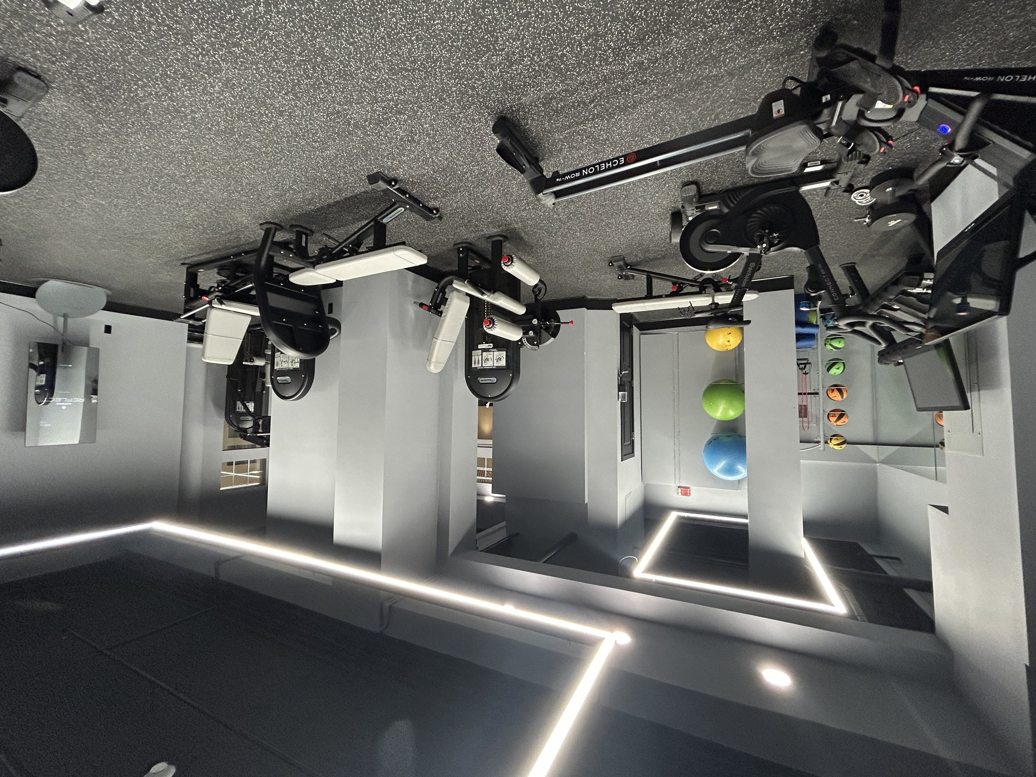 A room with a lot of lights and a white background.