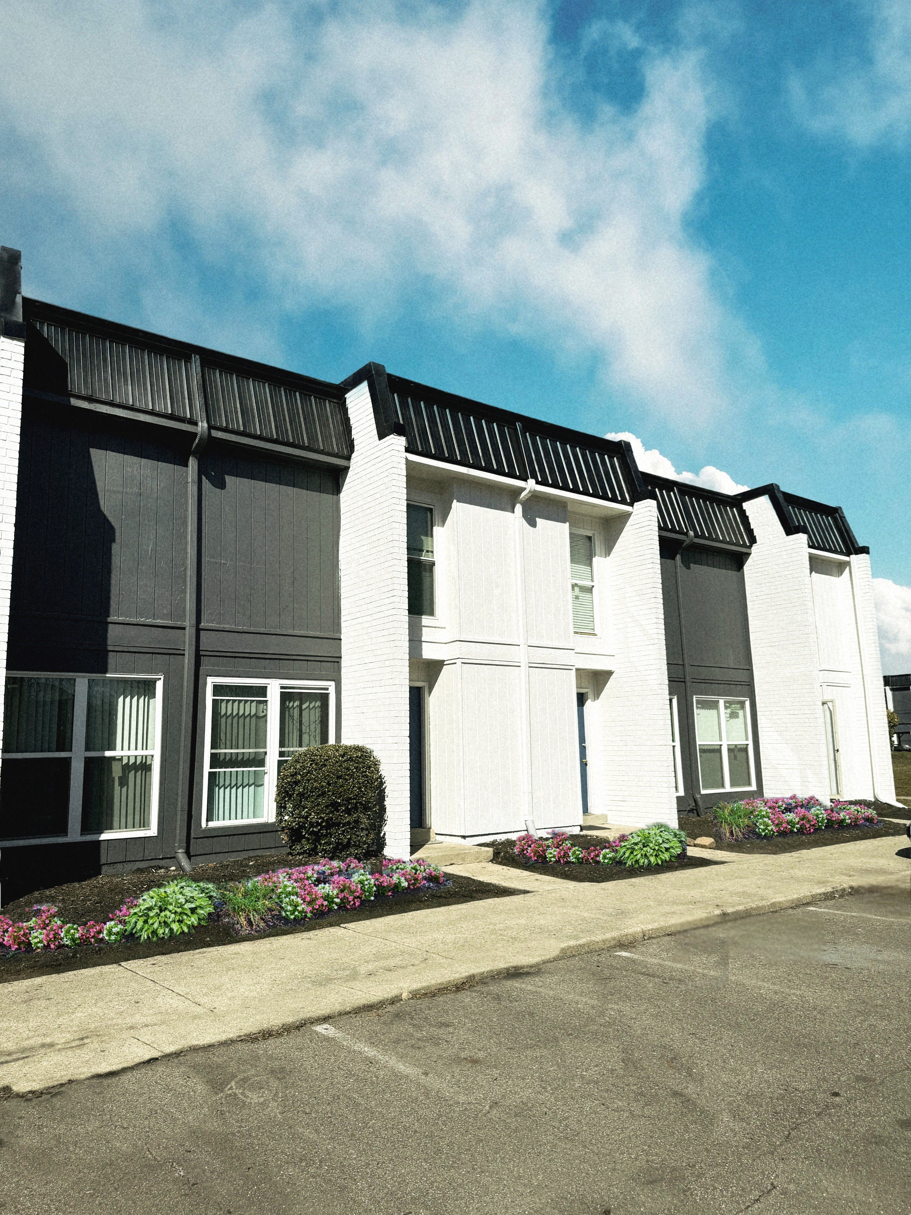A row of houses with white doors and windows.
