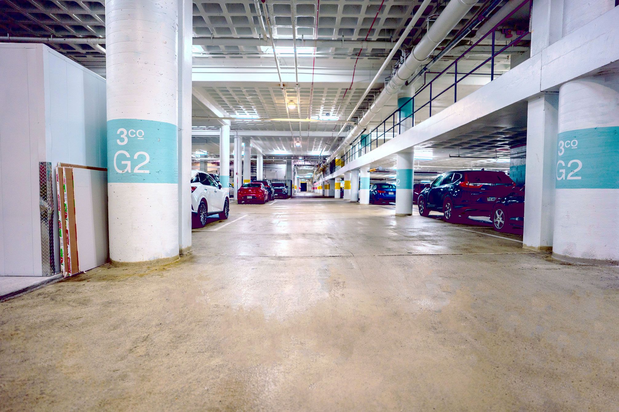 a parking garage with yellow arrows on the floor