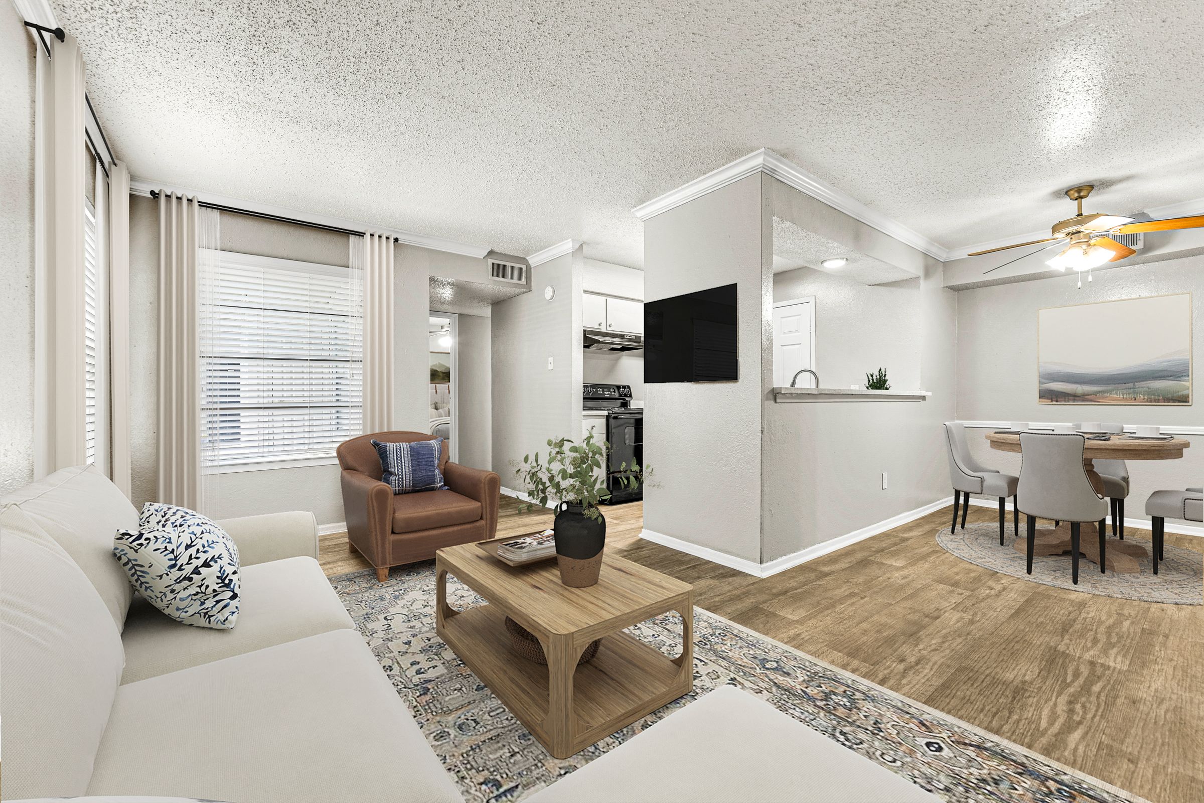 a living room with a couch and a table at 5636 Apartment Homes, Dallas, TX, 75254