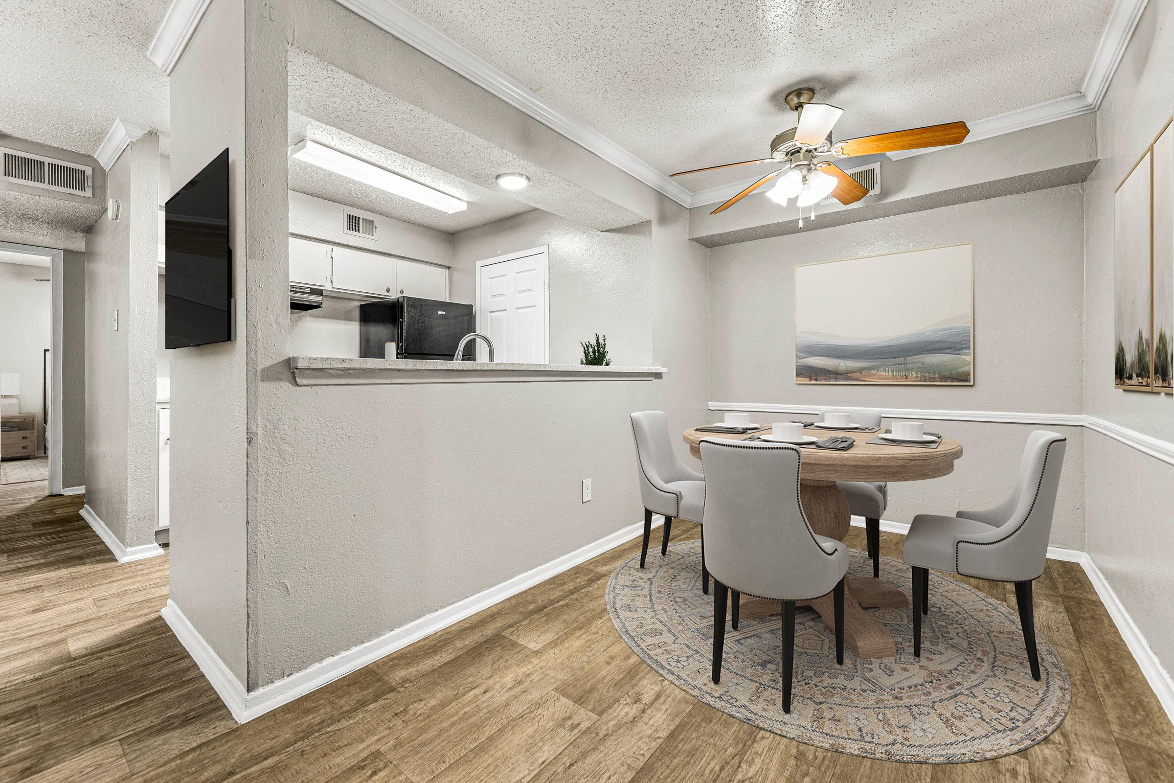 a dining room with a table and chairs and a ceiling fan at 5636 Apartment Homes, Dallas, TX  75254