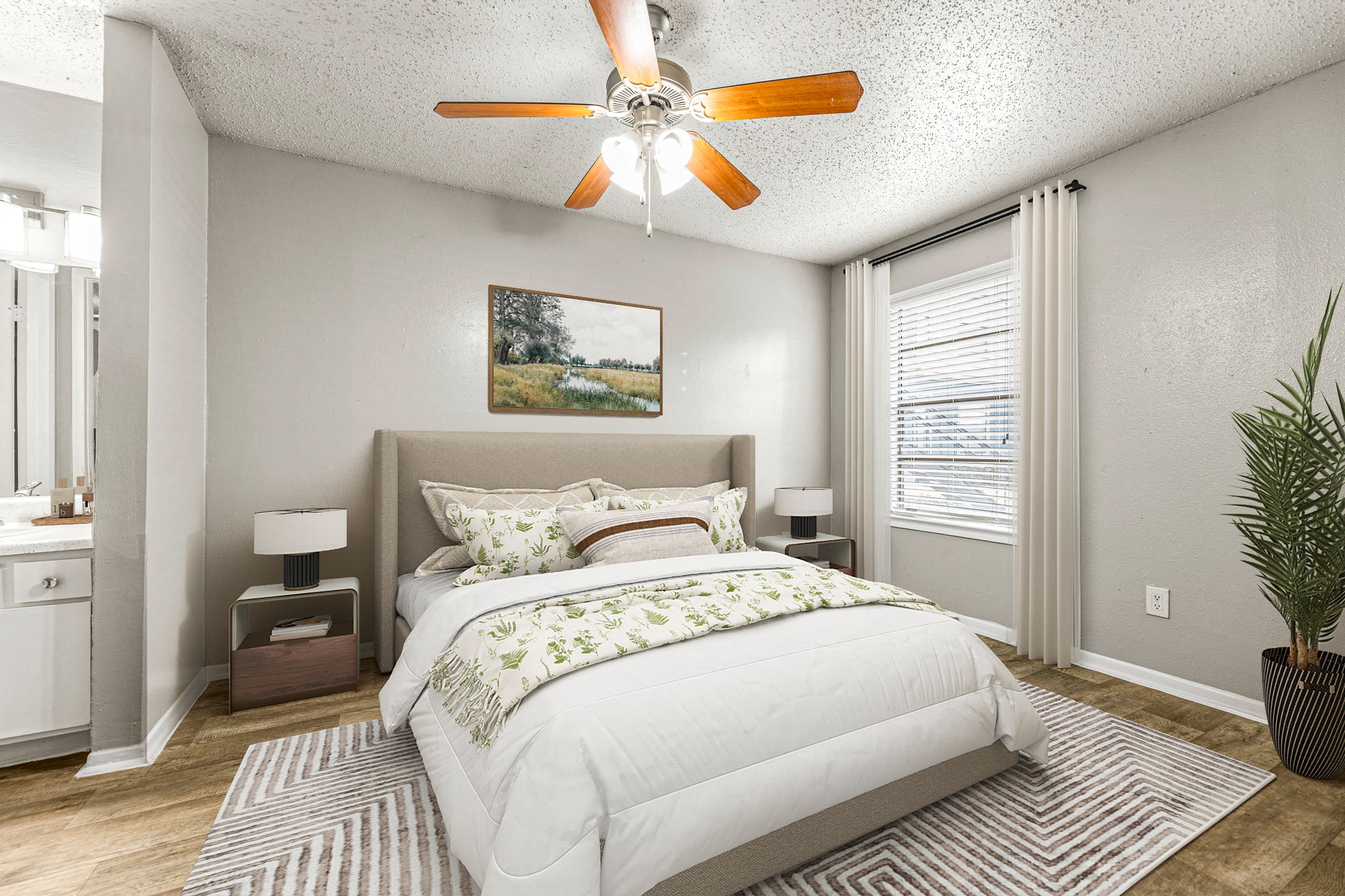 a bedroom with a bed and a ceiling fan at 5636 Apartment Homes, Dallas, TX  75254
