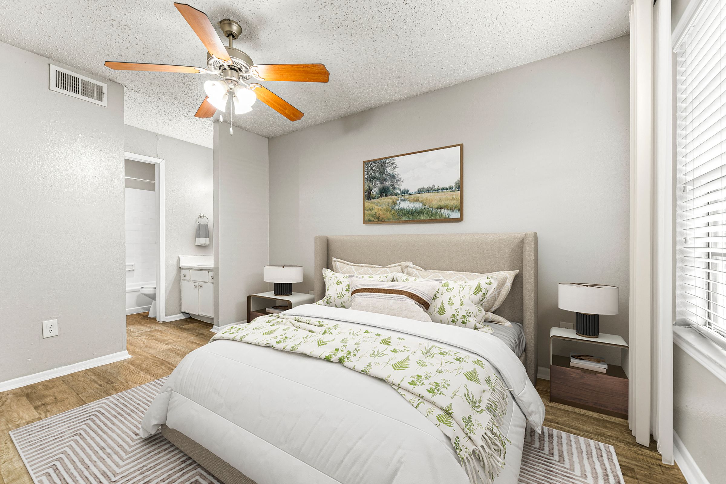 a bedroom with a large bed and a ceiling fan at 5636 Apartment Homes, Texas, 75254