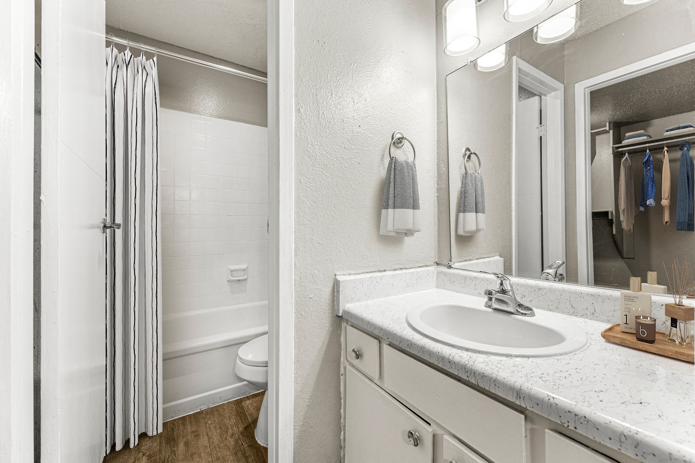 a bathroom with a sink and a shower and a mirror at 5636 Apartment Homes, Dallas, TX  75254