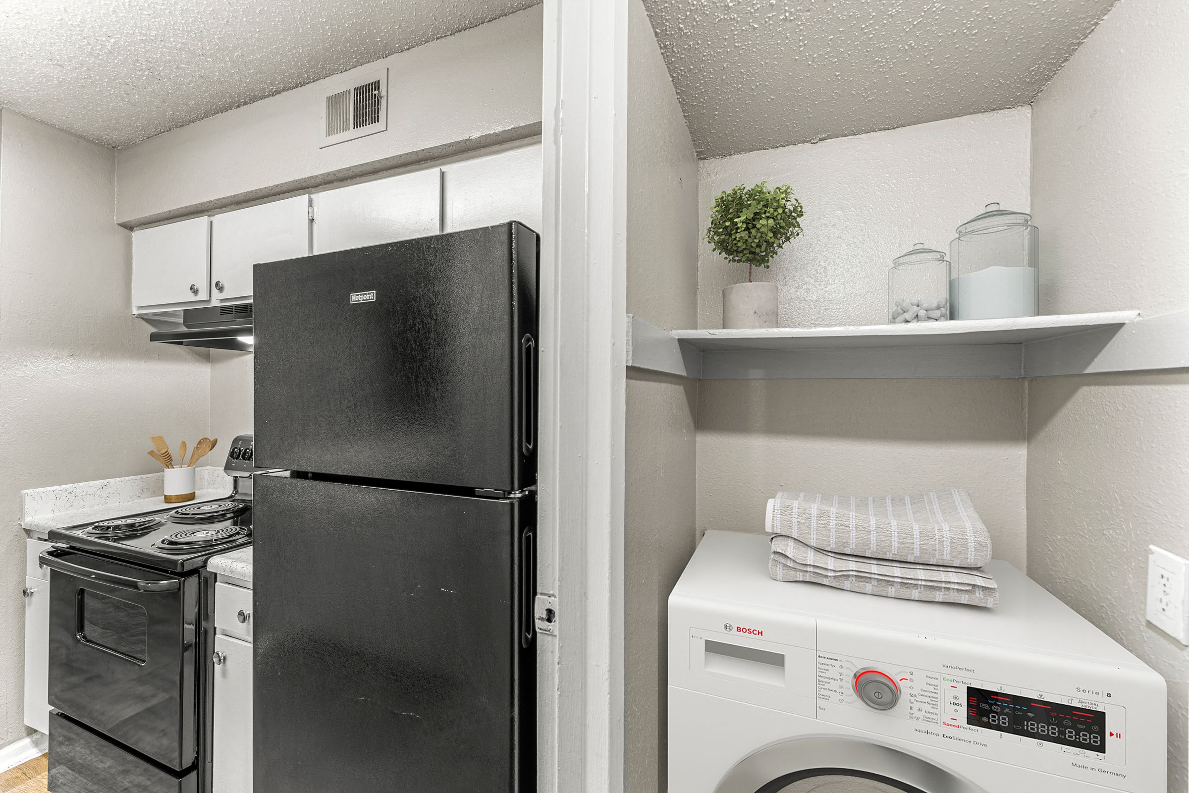 a laundry room with a refrigerator and a washing machine at 5636 Apartment Homes, Dallas, TX  75254