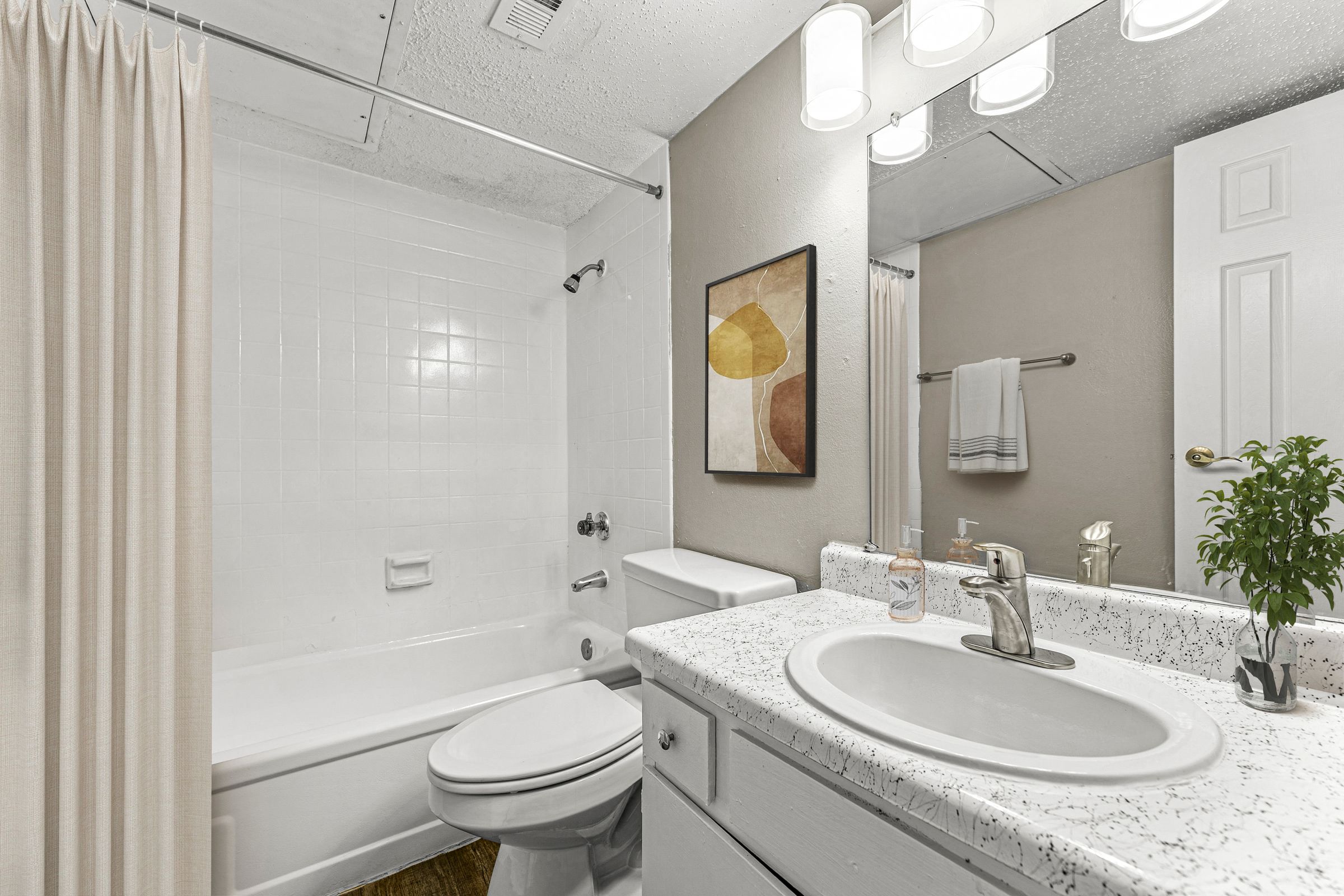 a bathroom with a sink and a toilet and a tub at 5636 Apartment Homes, Dallas, Texas  75254