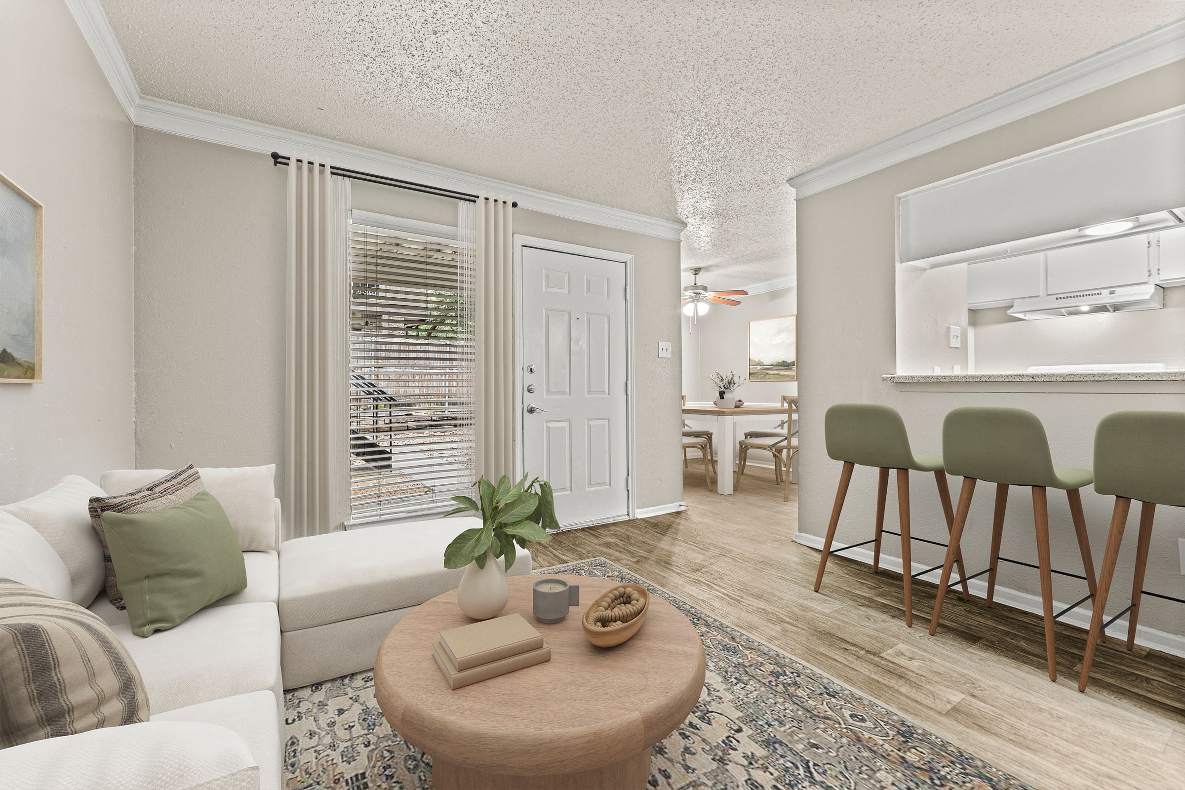 a living room with a couch and a table at 5636 Apartment Homes, Dallas, TX  75254