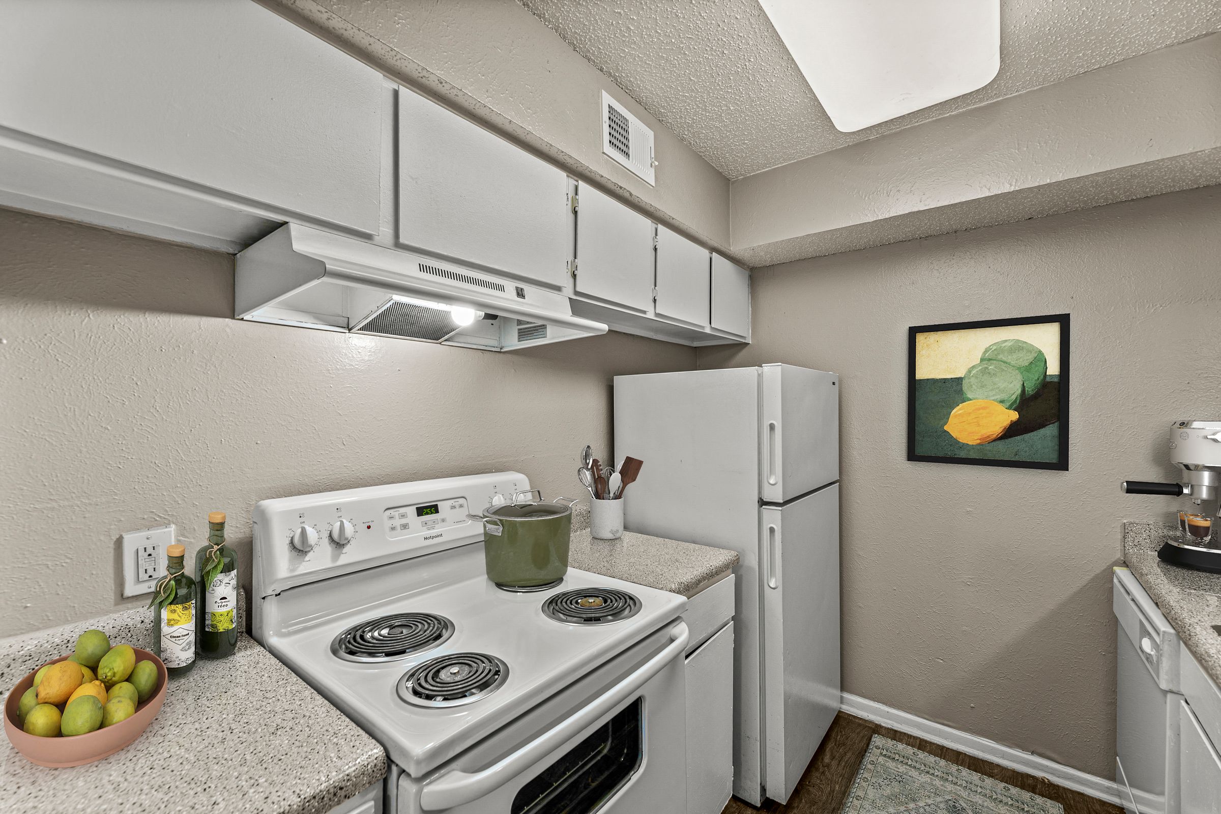 our apartments have a kitchen with white appliances and granite counter tops at 5636 Apartment Homes, Dallas, TX  75254