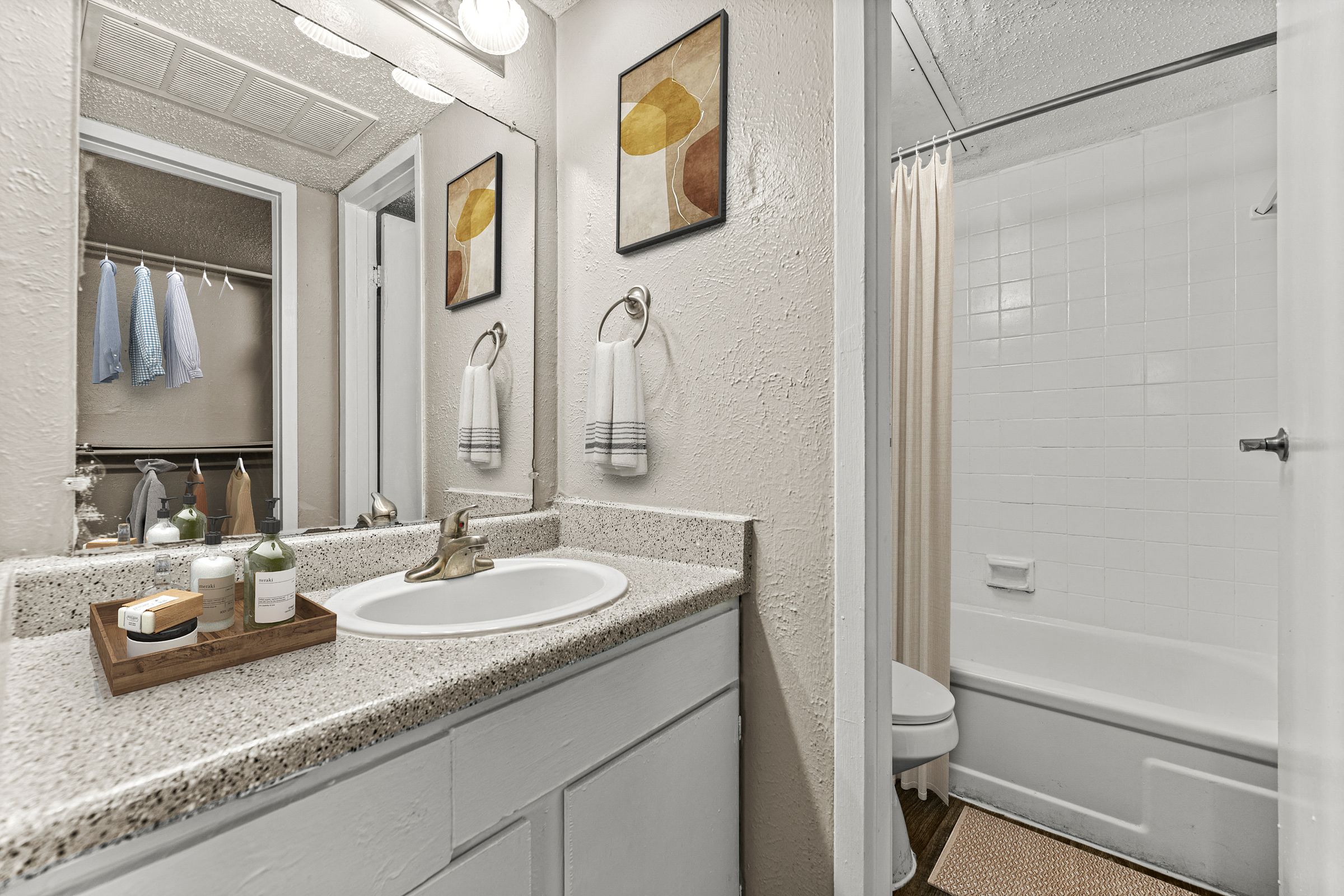 a bathroom with a sink and a shower and a mirror at 5636 Apartment Homes, Dallas, TX  75254