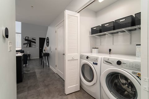a washer and dryer in a laundry room with a closet