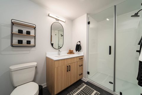 a bathroom with a toilet sink and shower