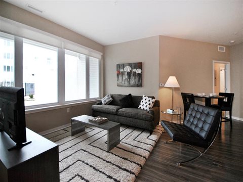 a living room filled with furniture and a large window at The George, Michigan