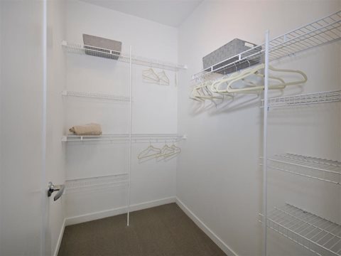 a walk in closet in a bedroom at The George, Ann Arbor