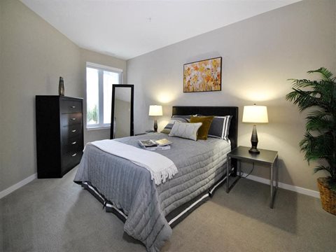 a bedroom with a large bed and a dresser at The George, Ann Arbor Michigan