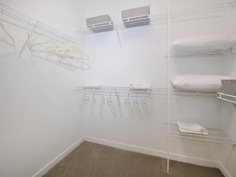 a bedroom with a bed and a closet at The George, Ann Arbor Michigan
