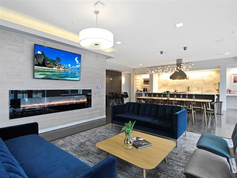 a living room filled with furniture and a flat screen tv at The George, Ann Arbor, MI 48104