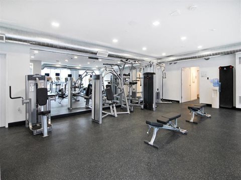 a gym with a lot of exercise equipment in it at The George, Ann Arbor, MI 48104