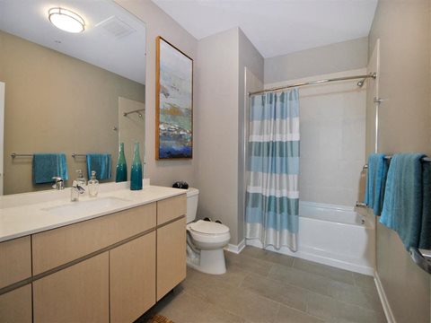 a bathroom with a toilet sink and bathtub at The George, Ann Arbor, 48104