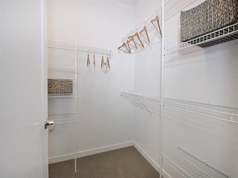 a walk in closet with white walls and a white door at The George, Michigan