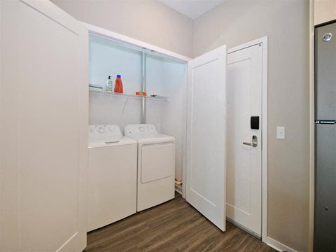 a laundry room with a washer and dryer at The George, Ann Arbor Michigan