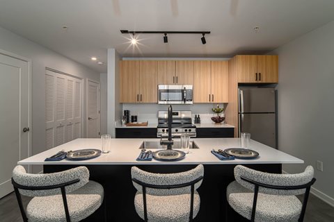 a kitchen with a large island with a table and chairs
