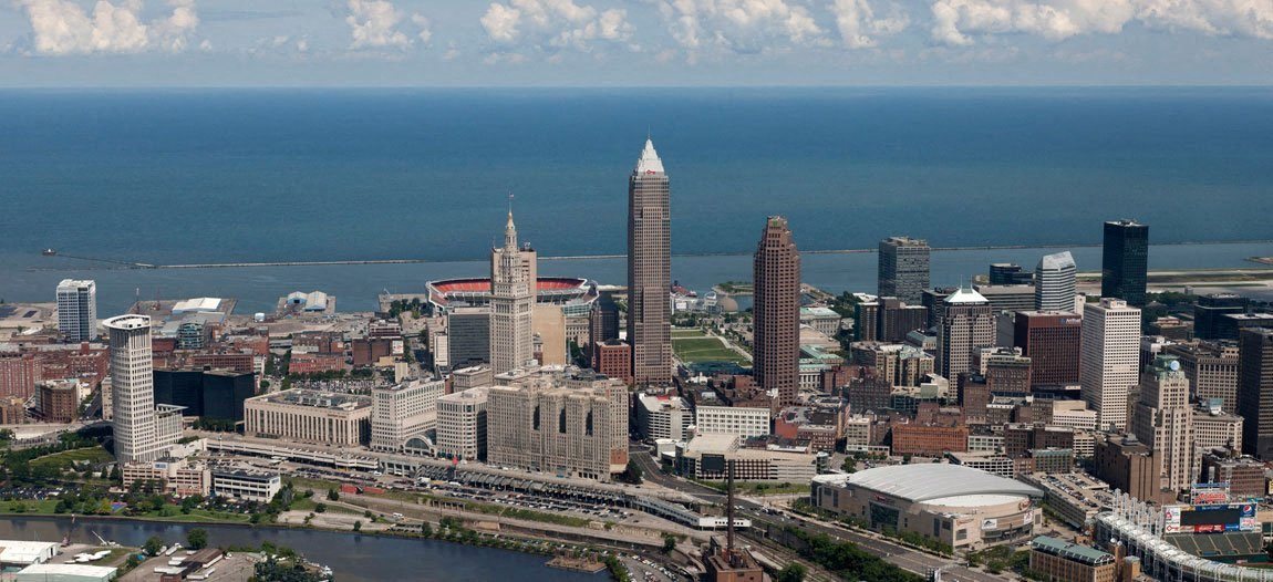 A city skyline with a large body of water in the background.