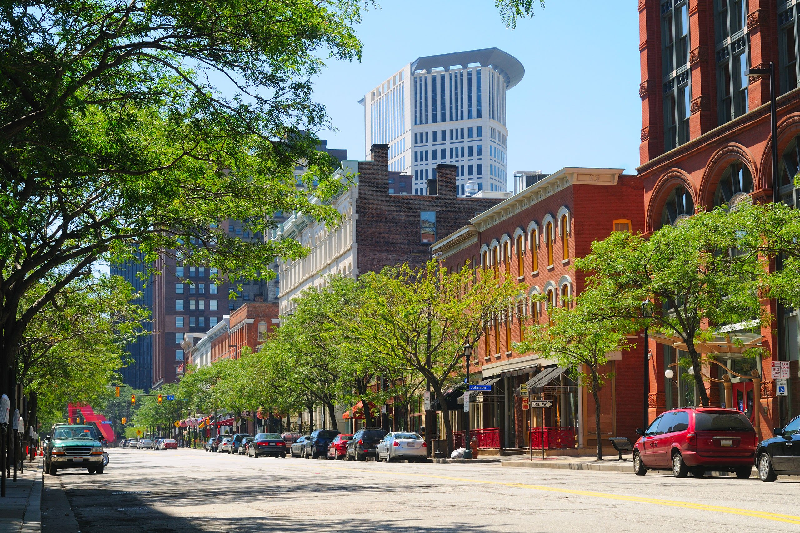A downtown street with cars and buildings At The Terminal Tower Residences in Cleveland