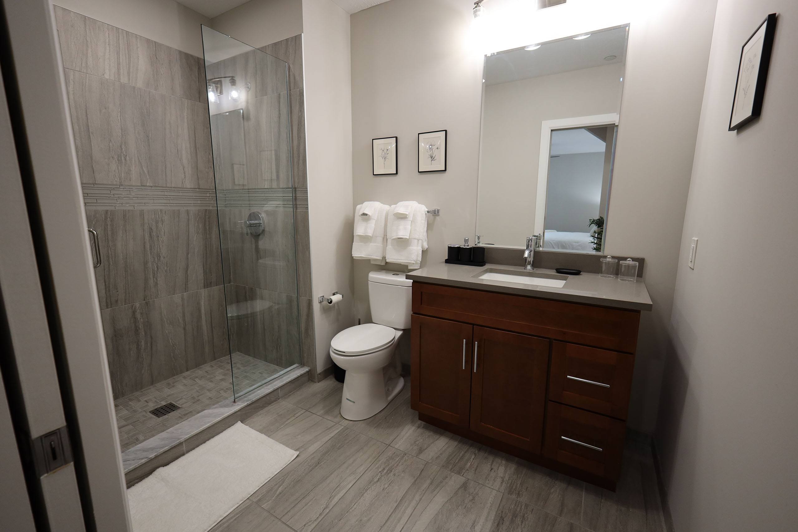 A bathroom with a toilet, sink, and shower.