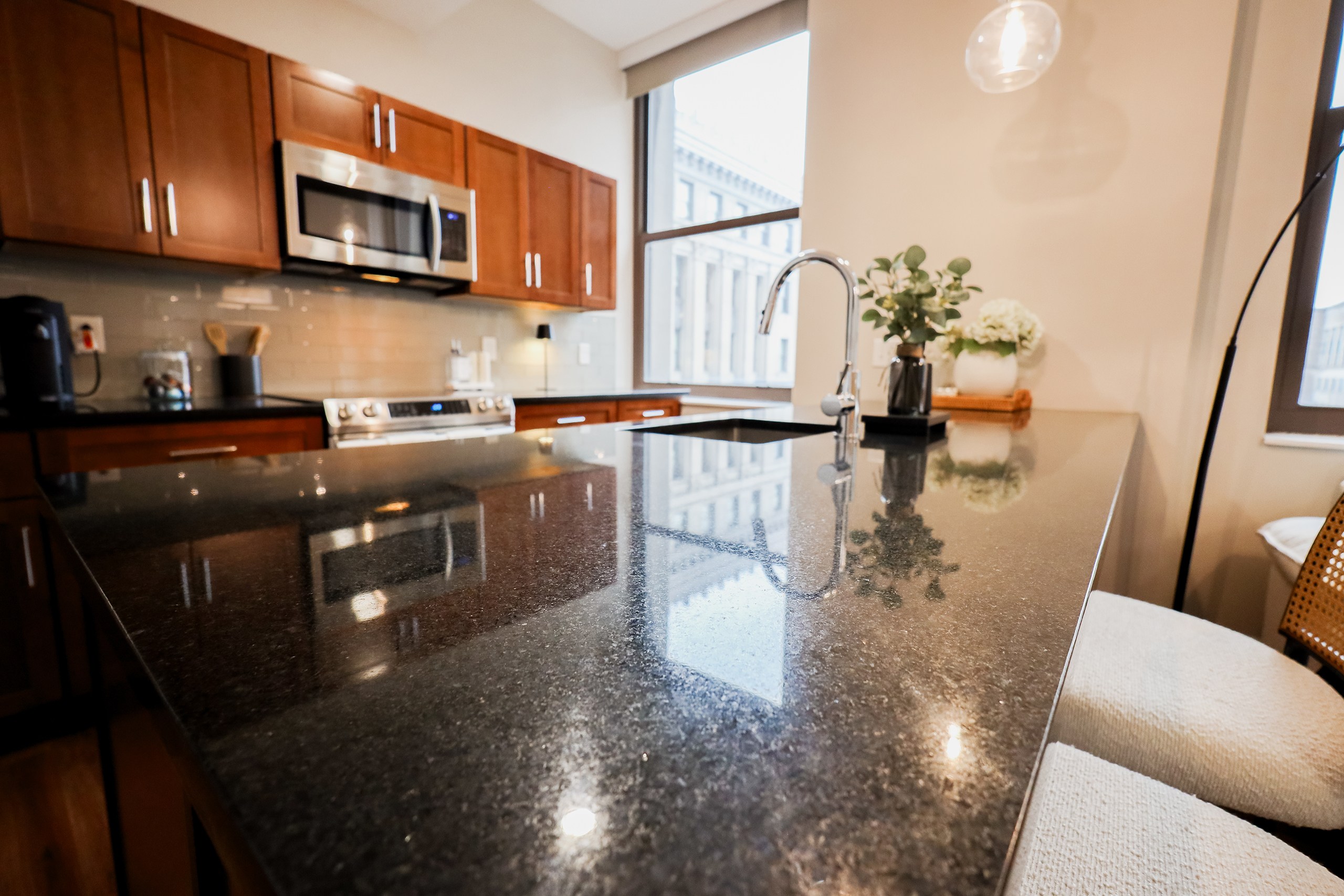 Kitchen with Granite Countertop and Modern Appliances at The Terminal Tower Residences Apartments, Ohio, 44113
