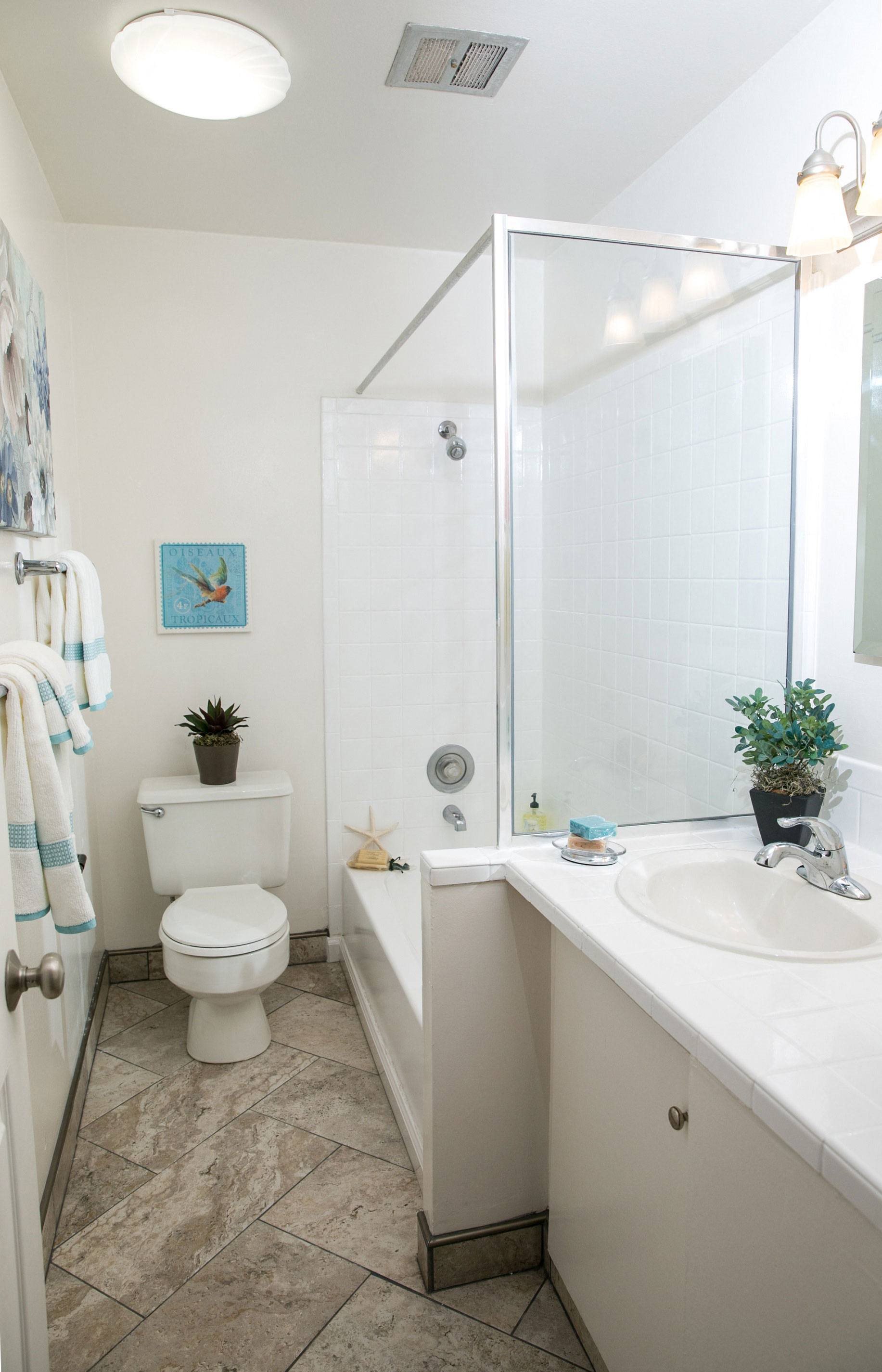 A small white toilet sits in a bathroom next to a sink.